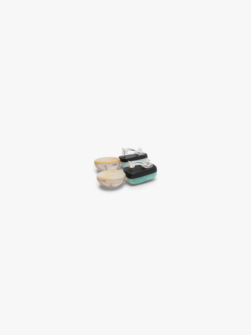 Pair of earrings with turquoise tops and crystal bases on a white background