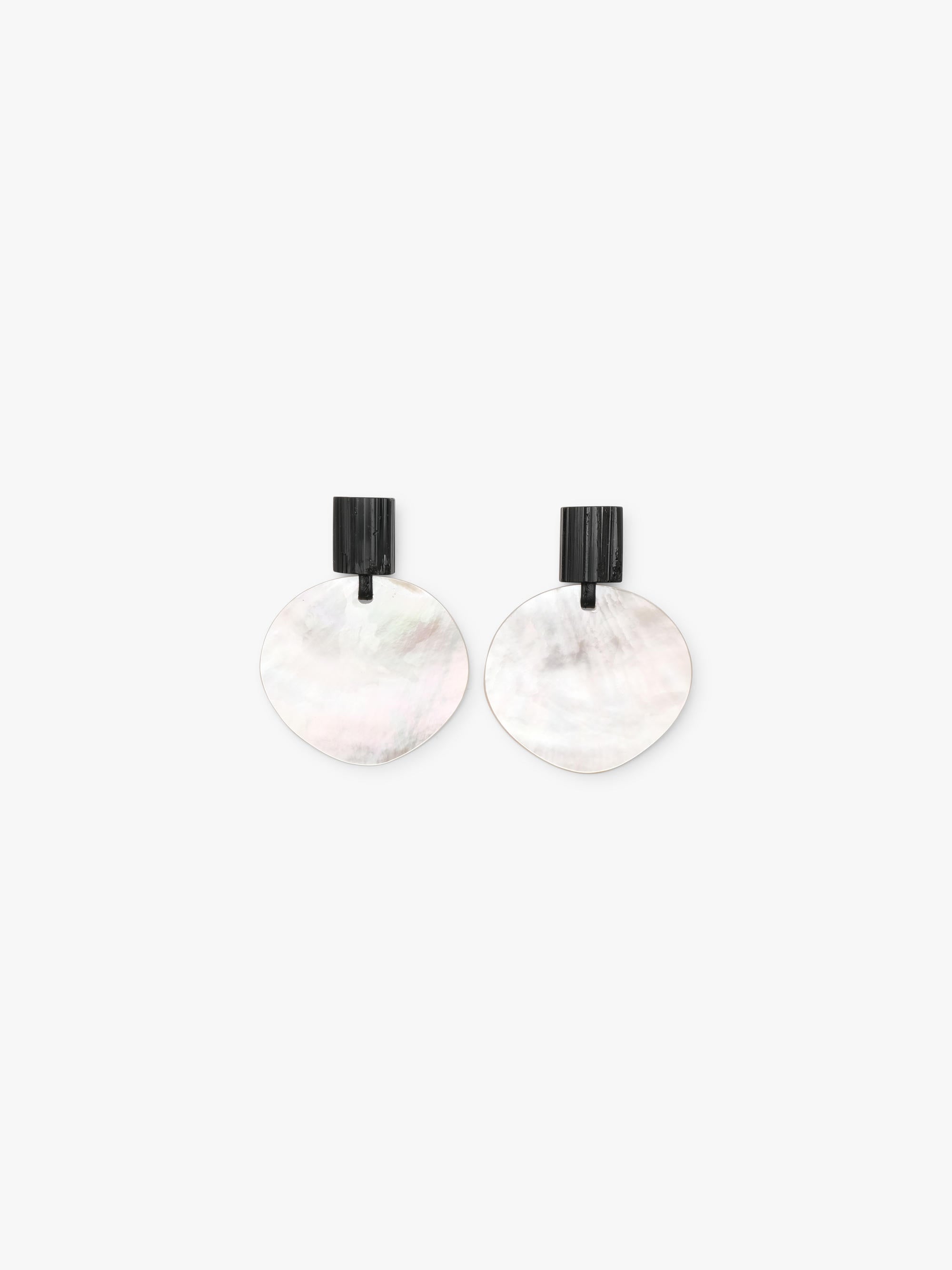 Pair of earrings with round white pearl and black tourmaline on a white background