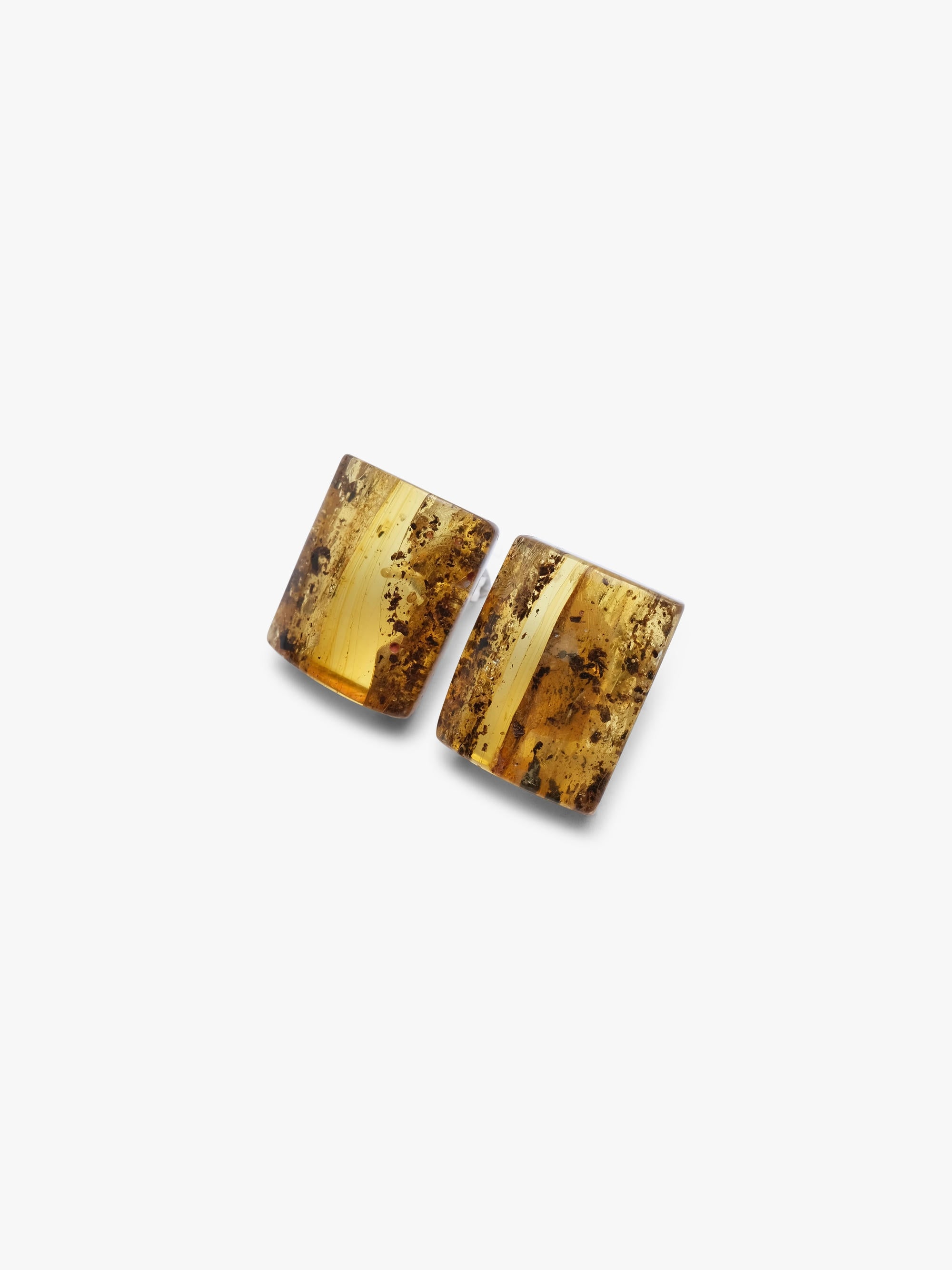 Pair of amber-colored earrings on a white background