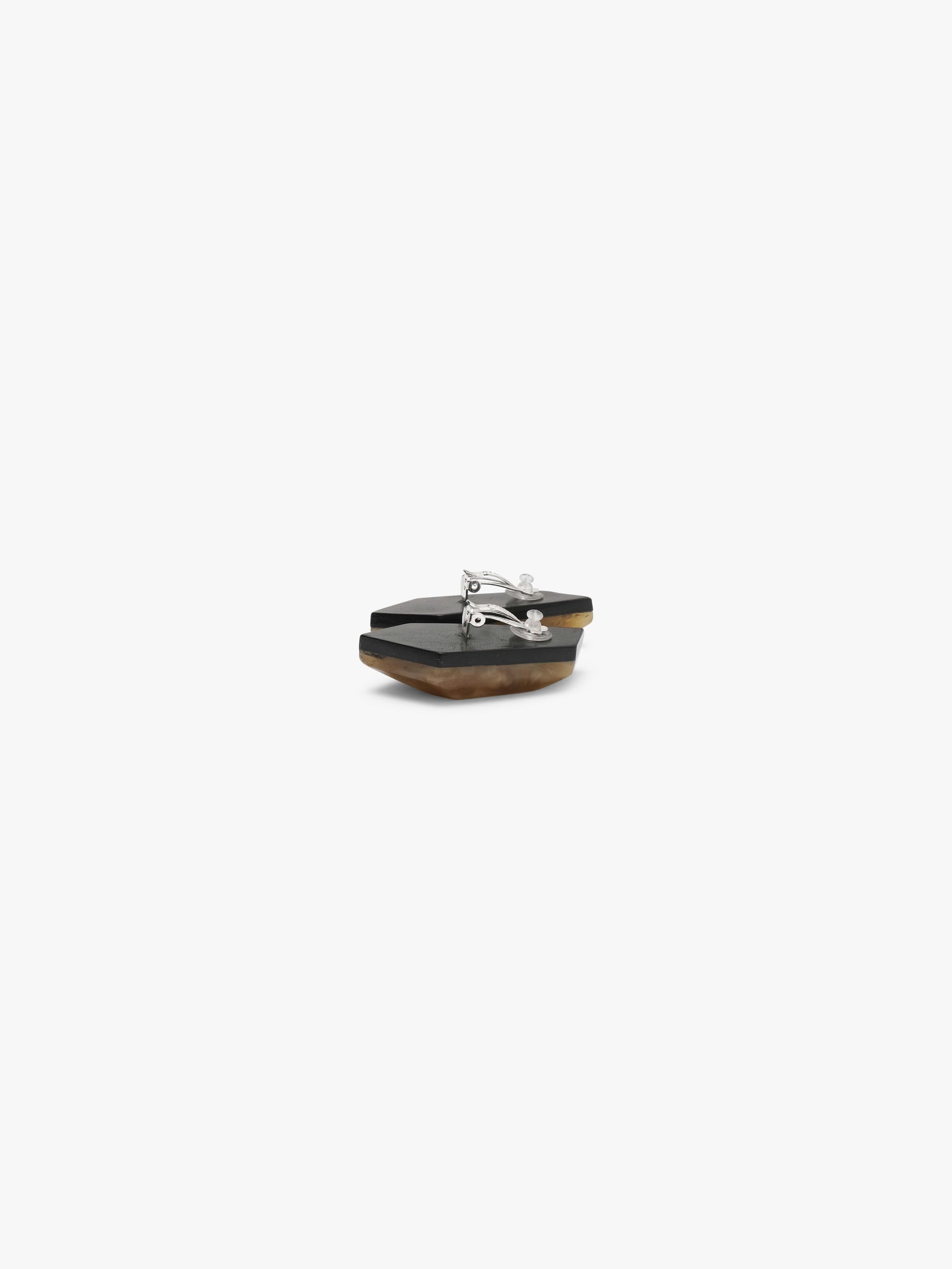 Two brown amber earrings on a white background