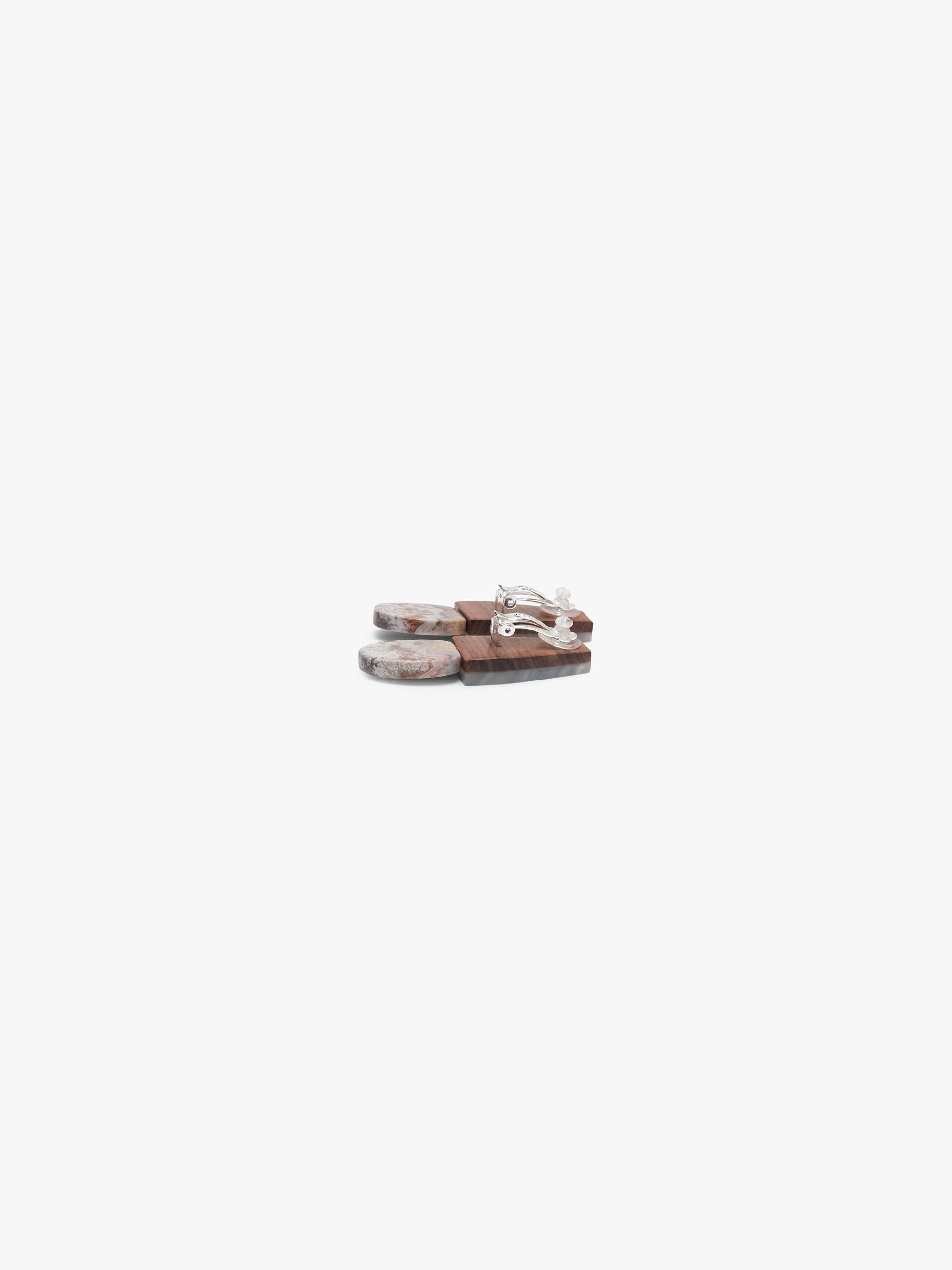 Two stone earrings with a geometric design on a white background