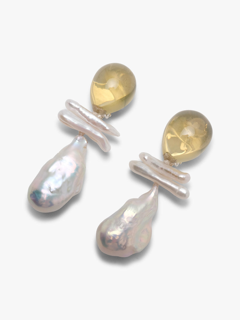 Pair of earrings with teardrop-shaped pearls and citrine stones on a white background
