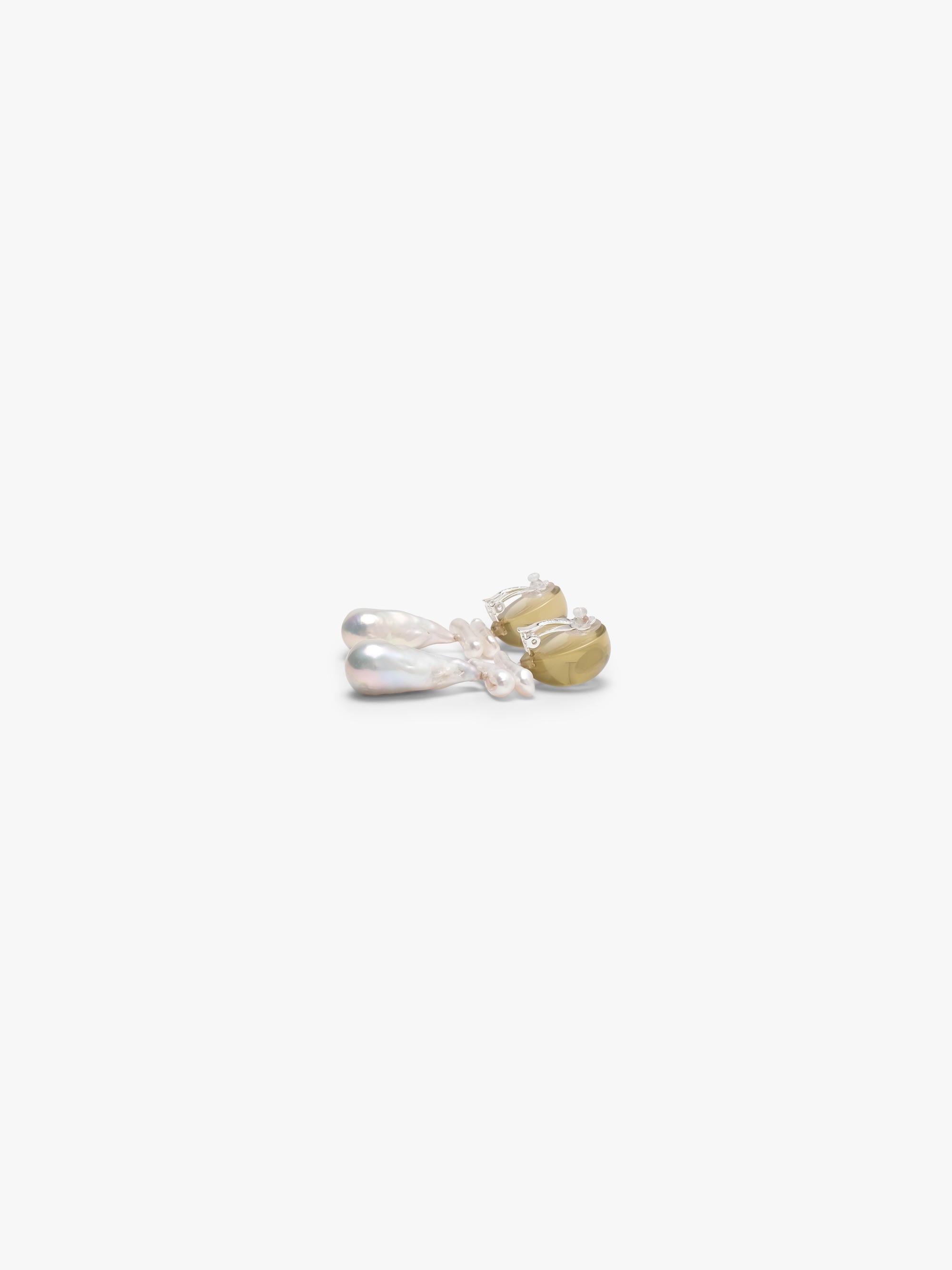 Pair of earrings with teardrop-shaped pearls and citrine stones on a white background