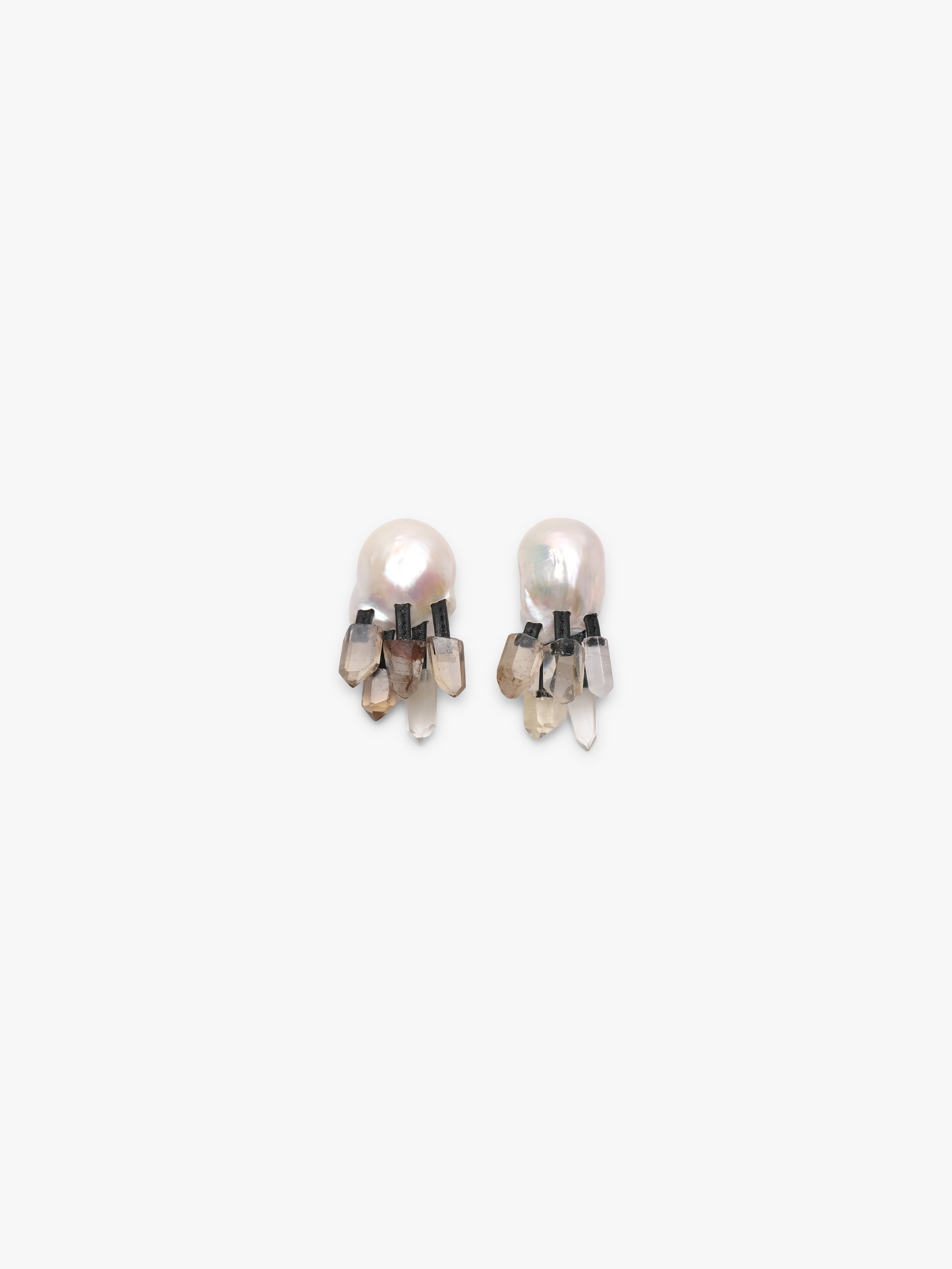 Baroque pearl earrings with citrine and quartz details on a white background.
