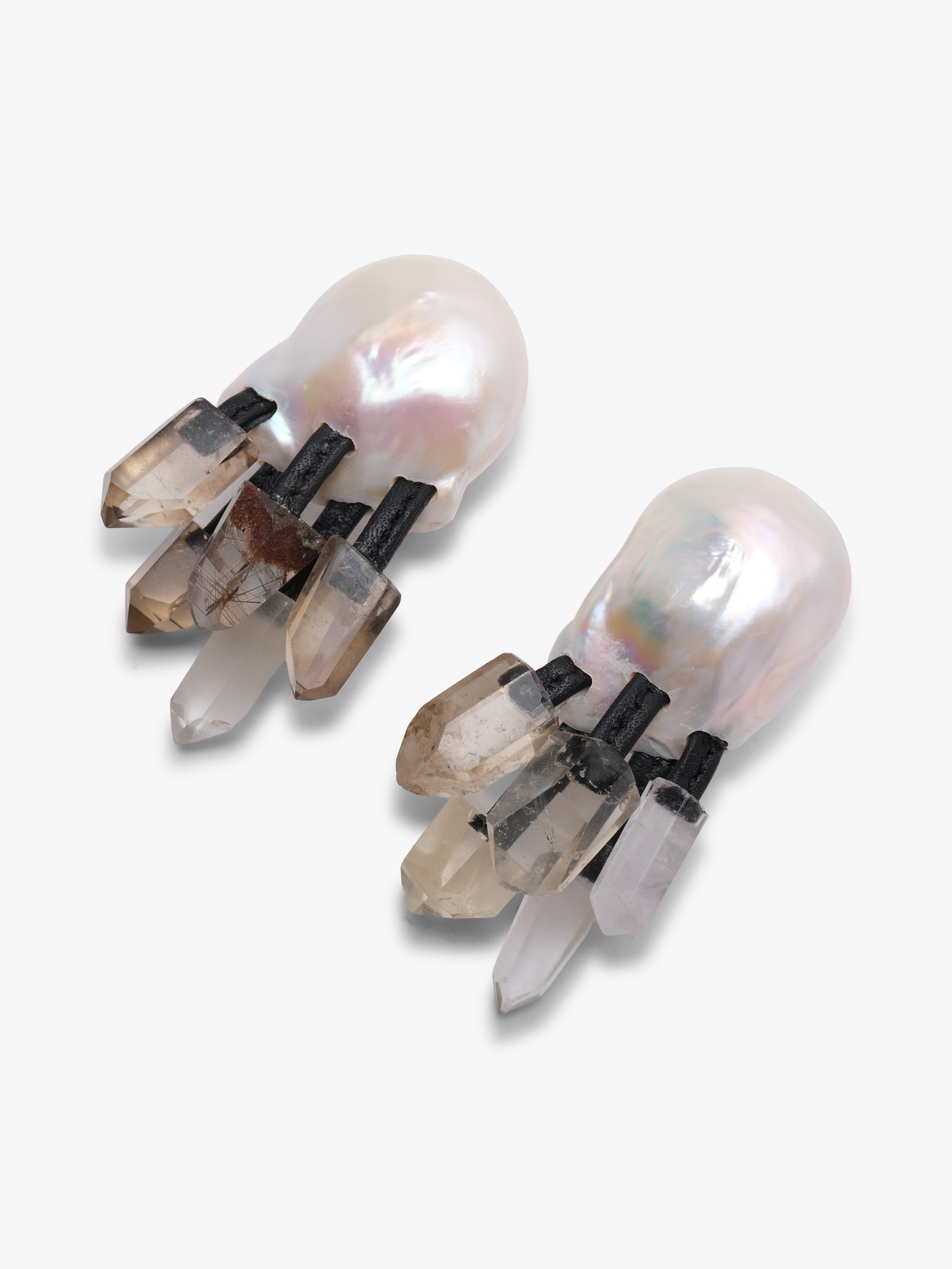 Pair of earrings with pearls and crystals on a white background