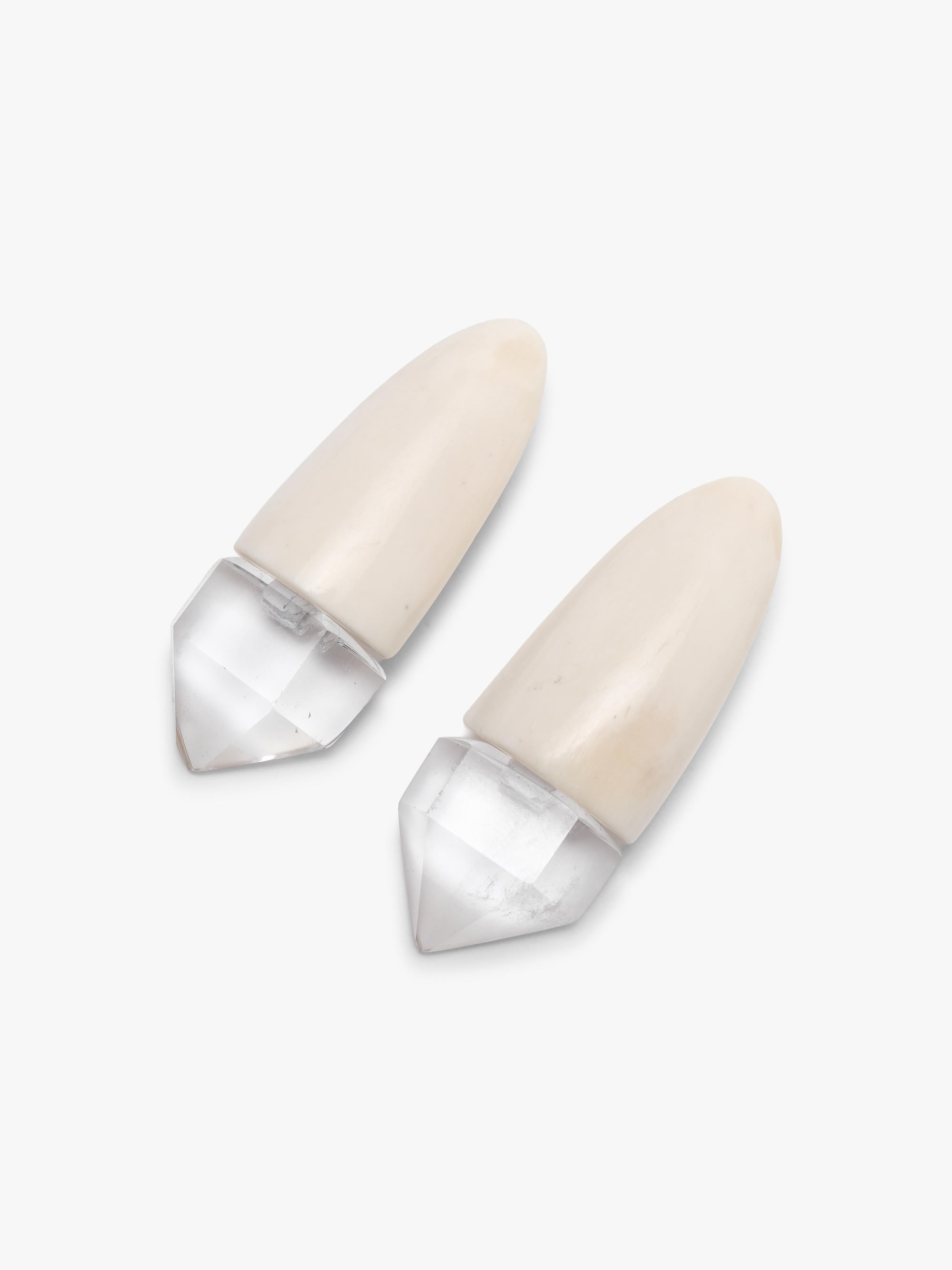Pair of beige bone and quartz earrings on a white background