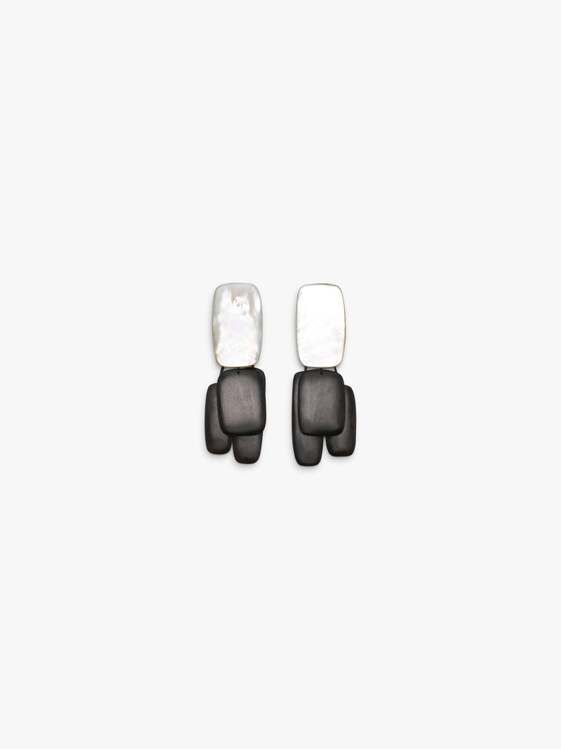 Pair of earrings with black wood and pearl design on a white background