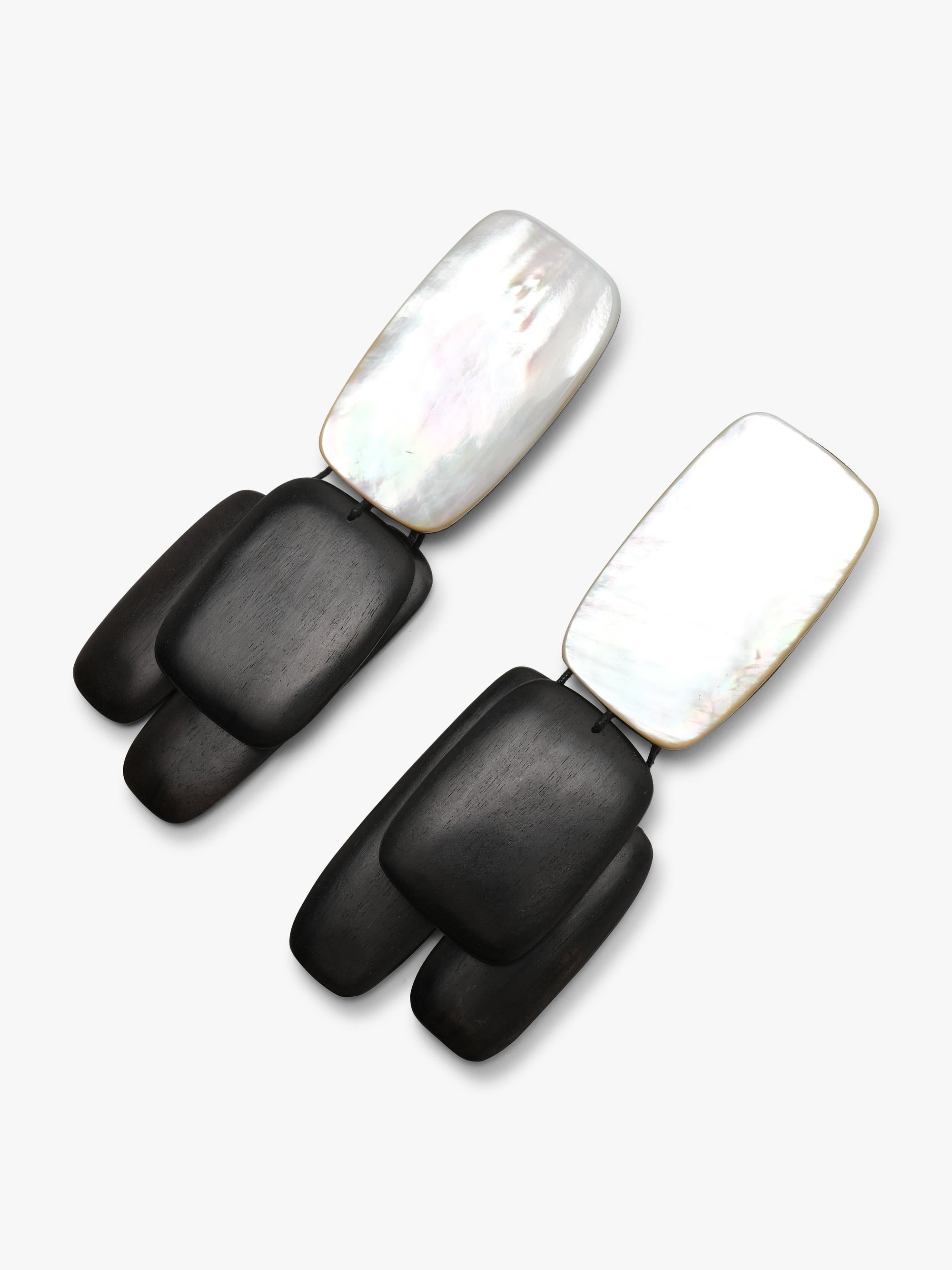 Pair of earrings with black wood and pearl design on a white background