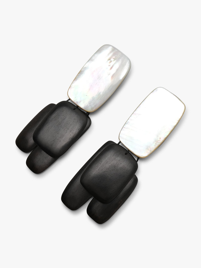 Pair of earrings with black wood and pearl design on a white background