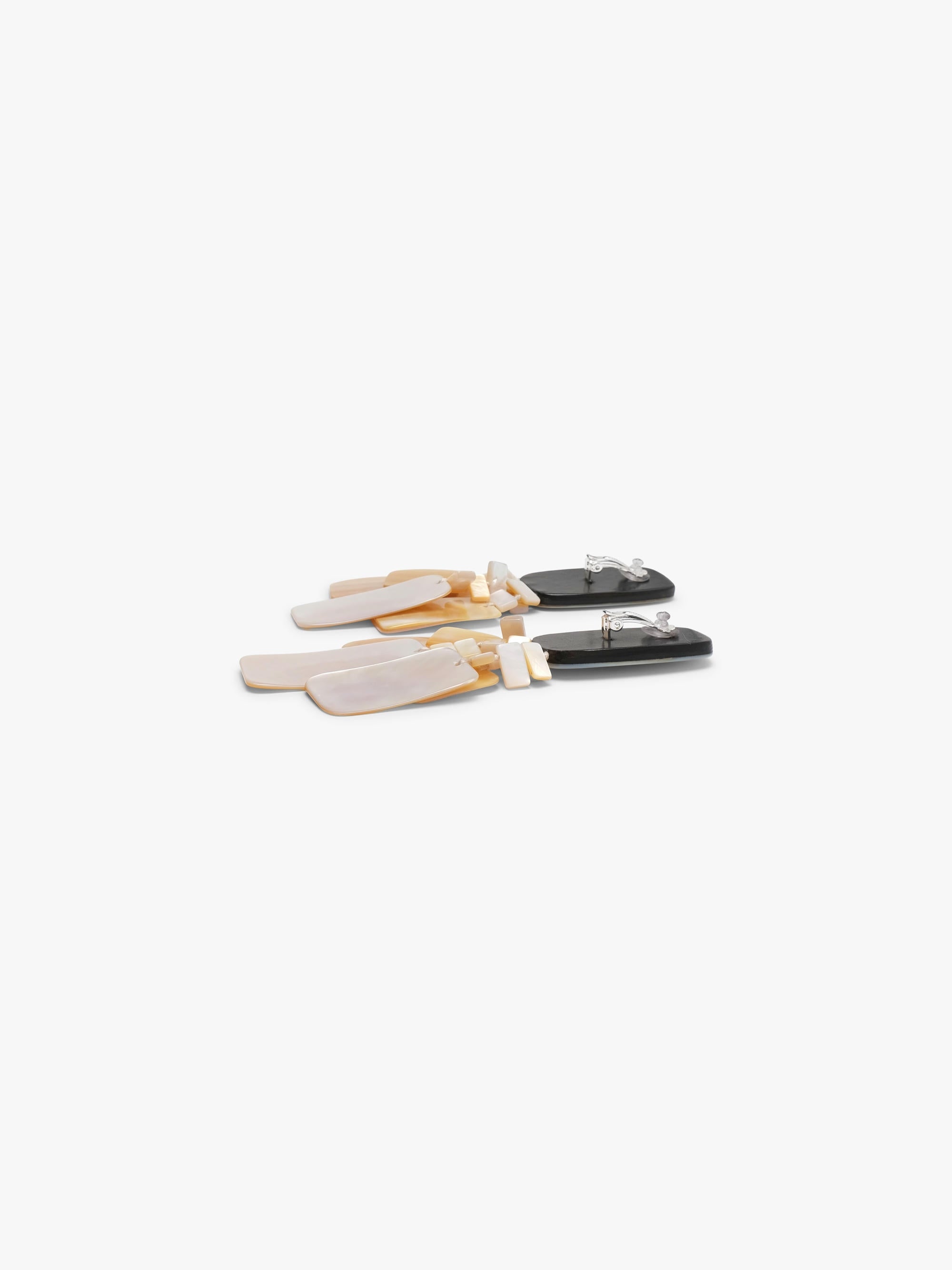 Pair of earrings with pearl design on a white background