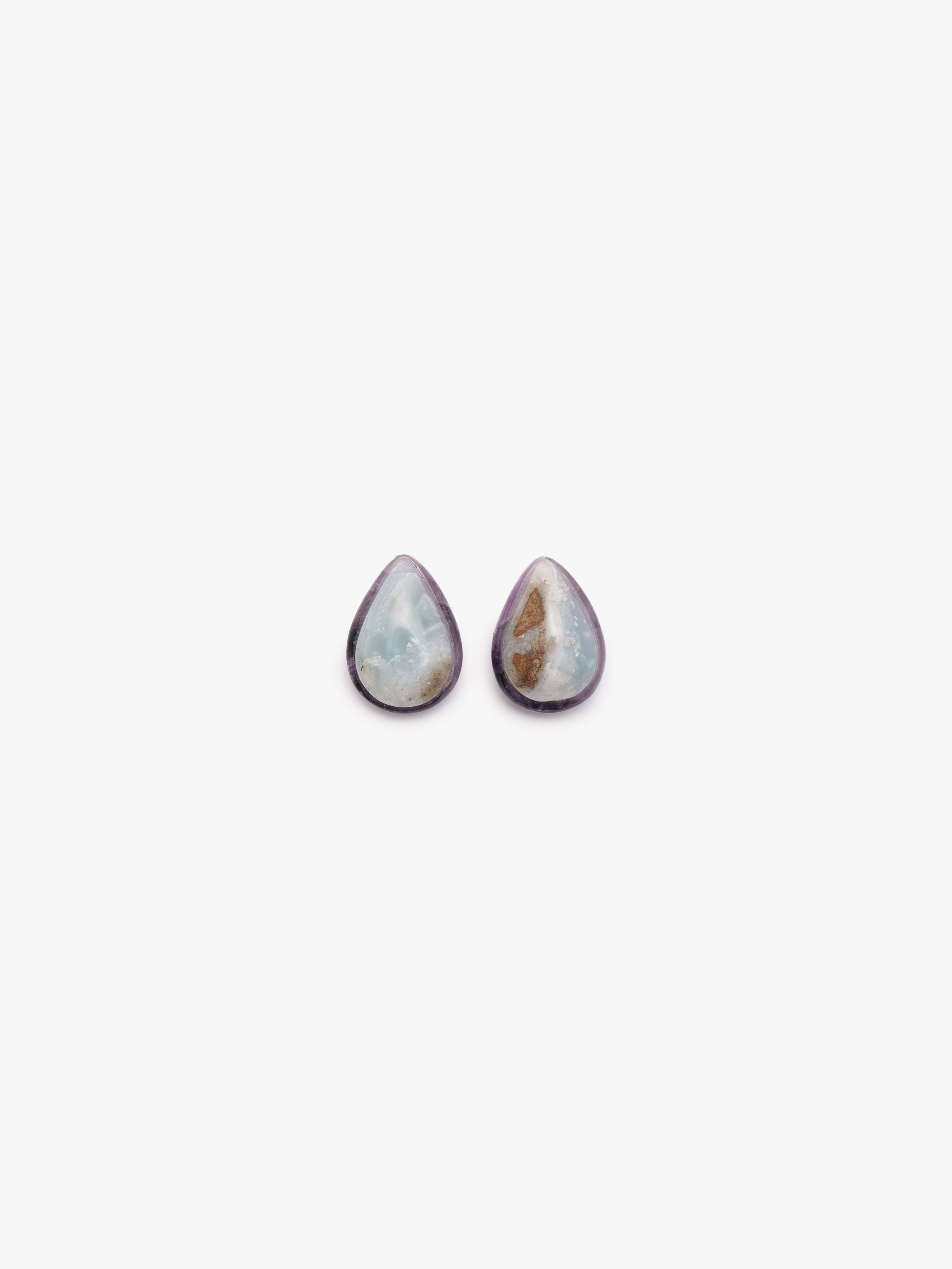 teardrop shaped earrings with blue, purple and brown hues on a white background