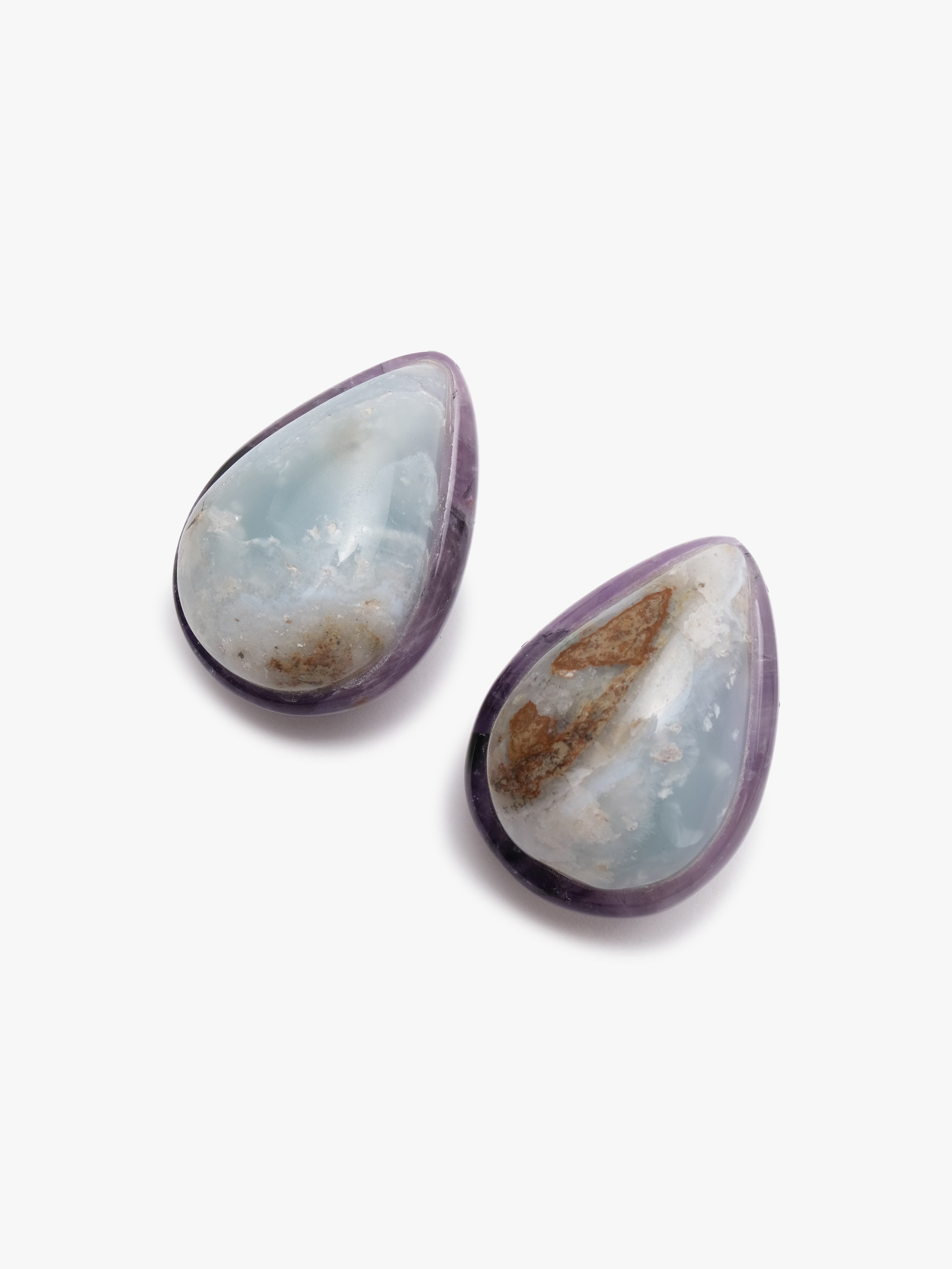 teardrop shaped earrings with blue, purple and brown hues on a white background