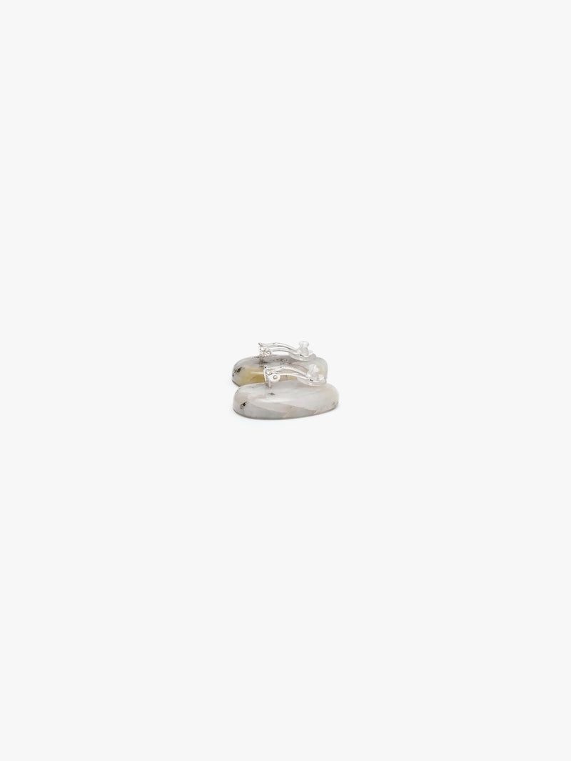 A pair of small stud earrings with oval, organic-shaped turquoise green stone inlays set in a silver-tone metal, shown against a plain white background.