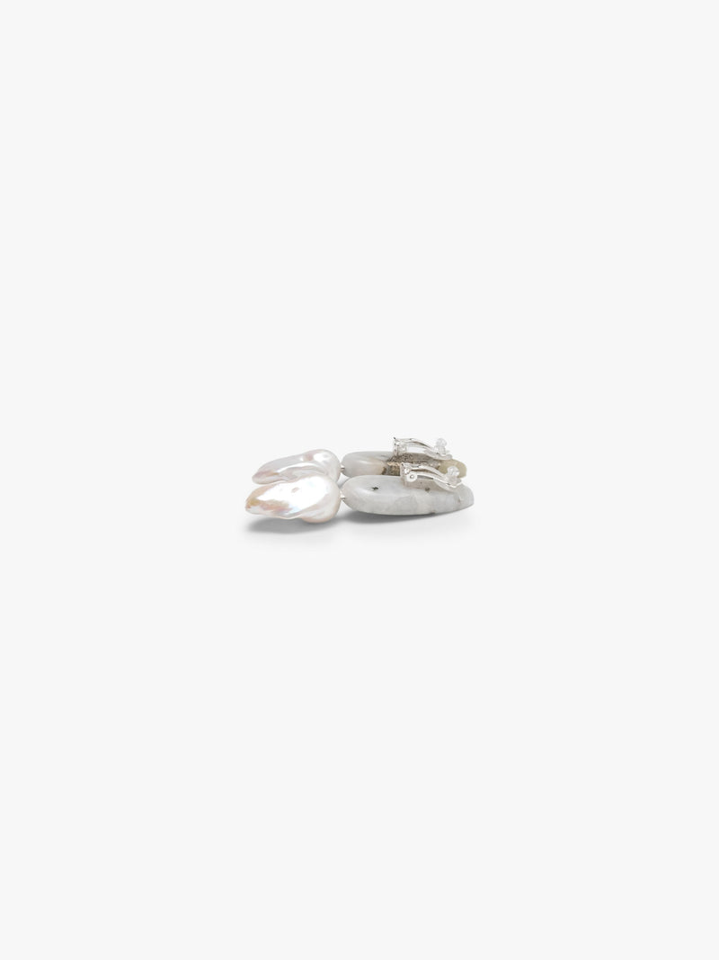 A pair of small drop earrings with green stone tops and baroque pearls, shown on a plain light gray background.