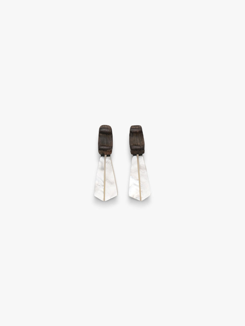 Pair of white earrings with black accents on a light gray background