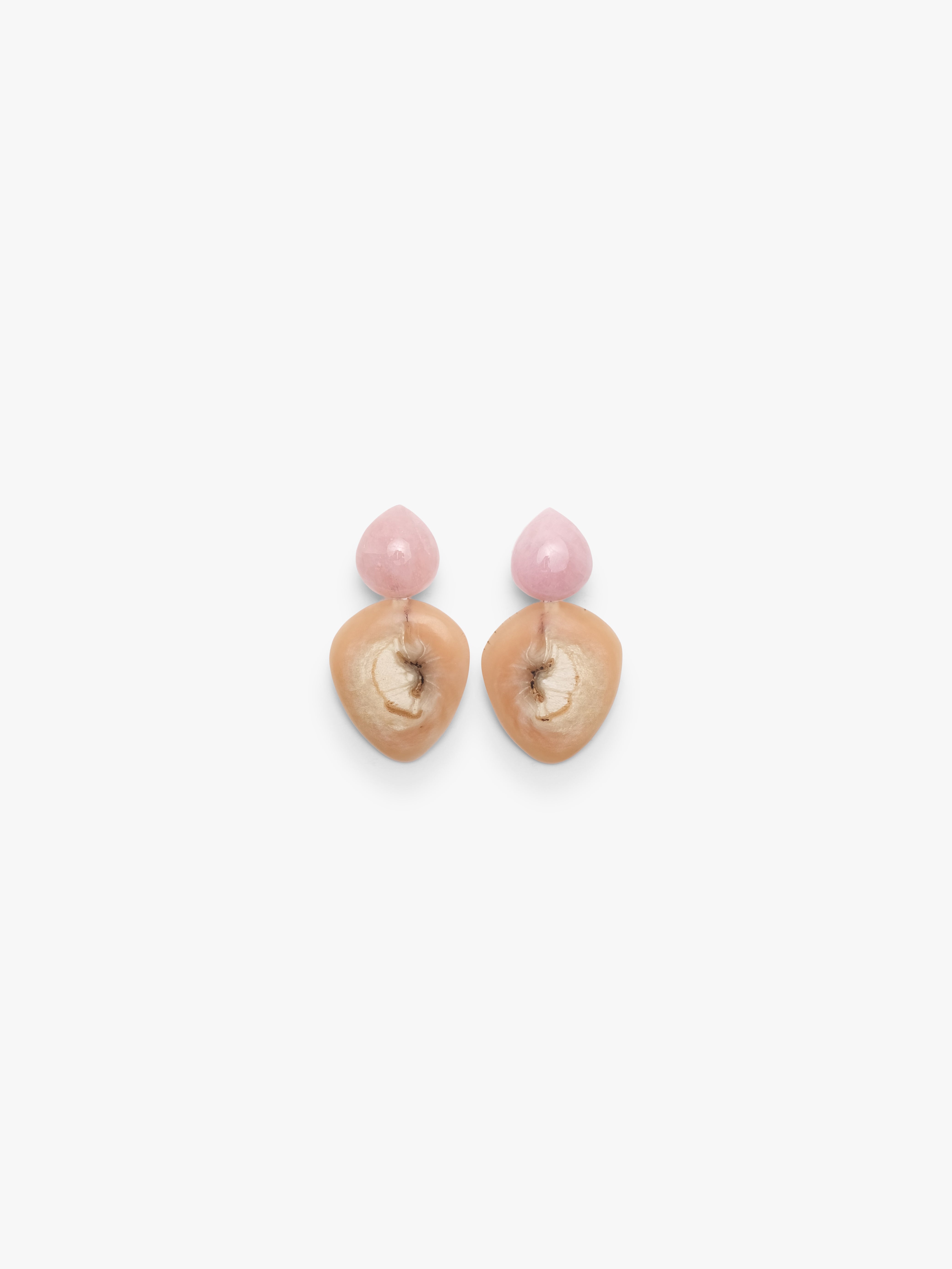 Pink and beige earrings mad eof horn and rose quartz on a white background