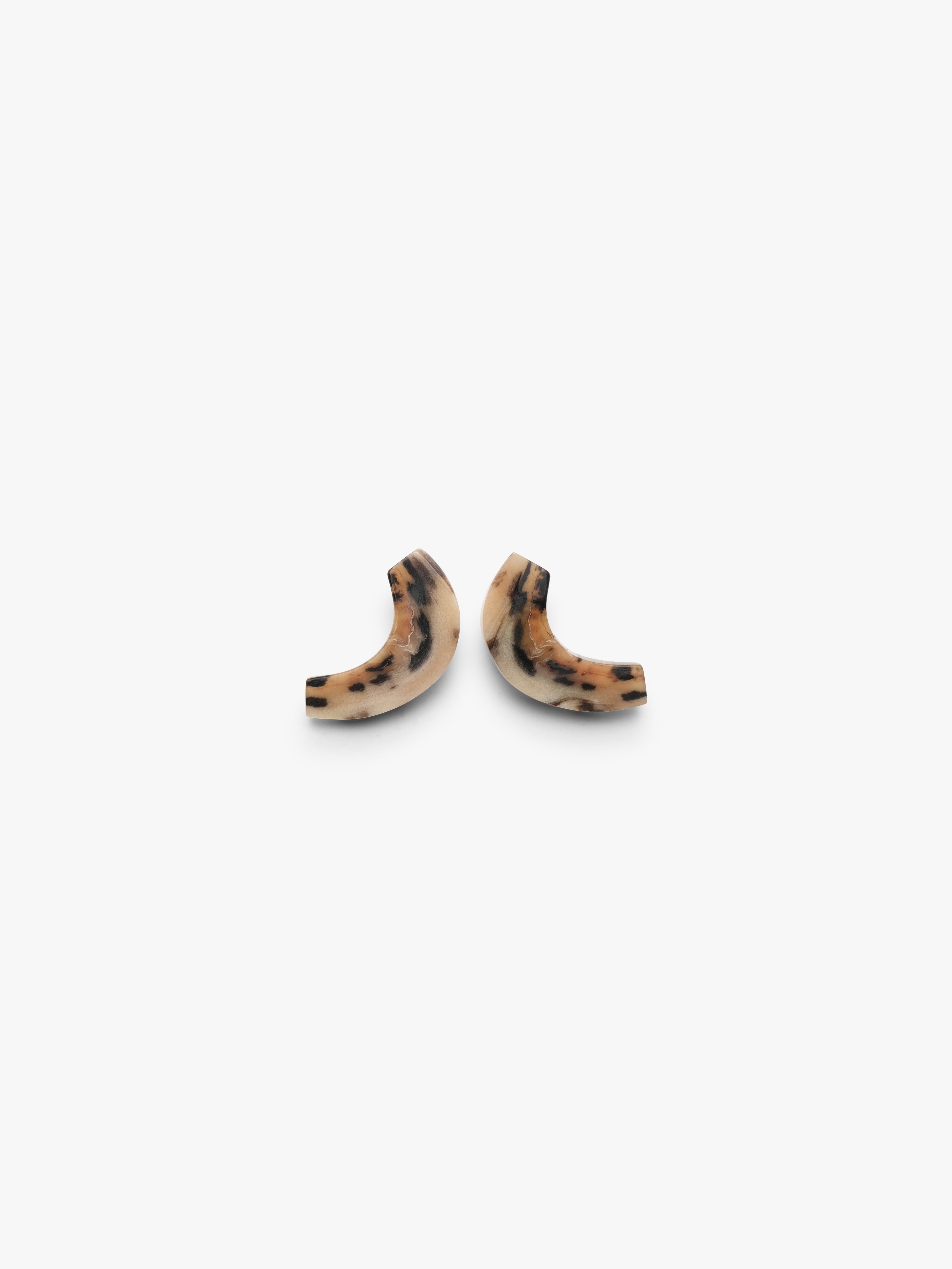 Two curved earringsin horn on a white background