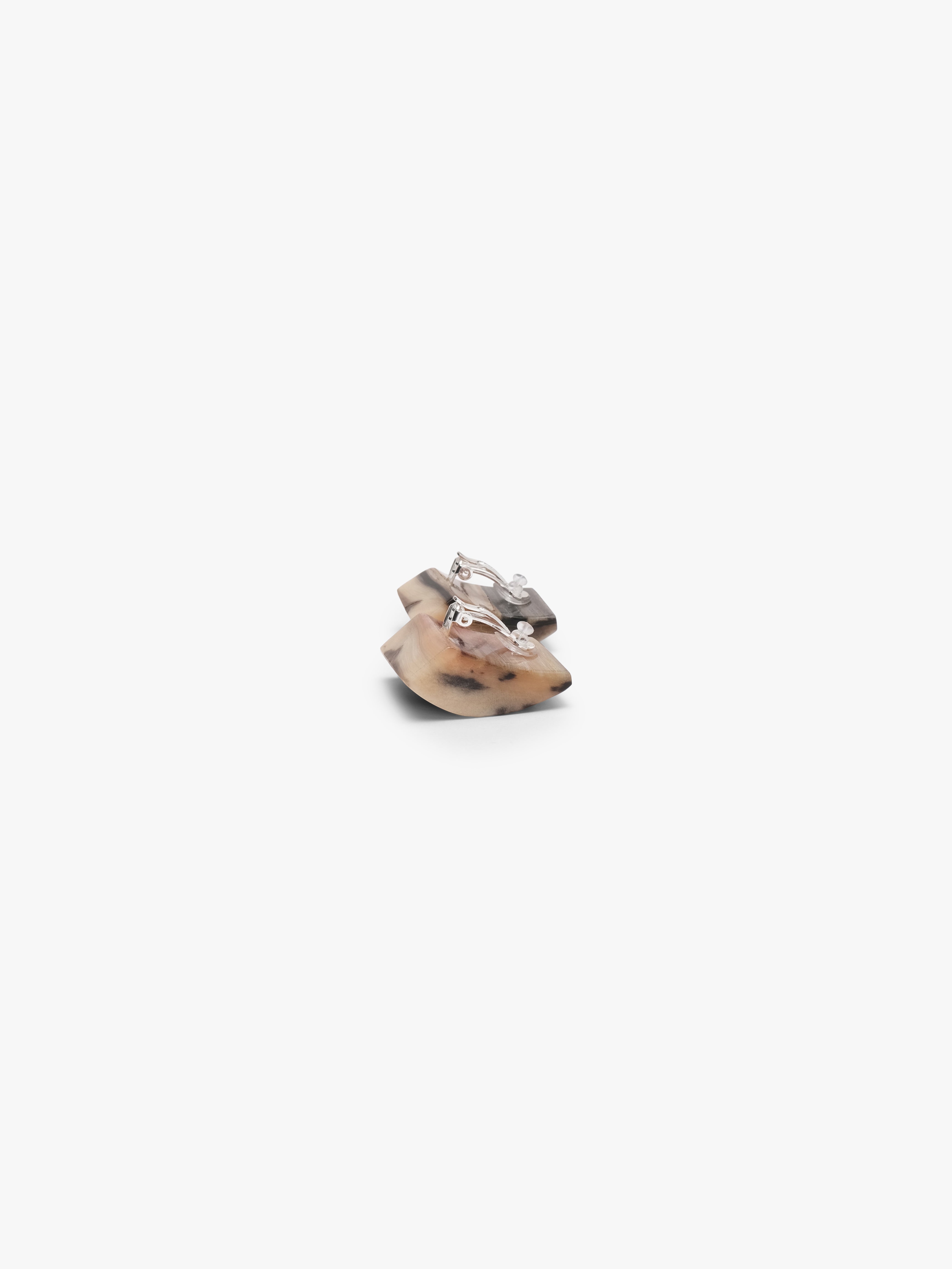 Square earrings with white and brown details on a white background