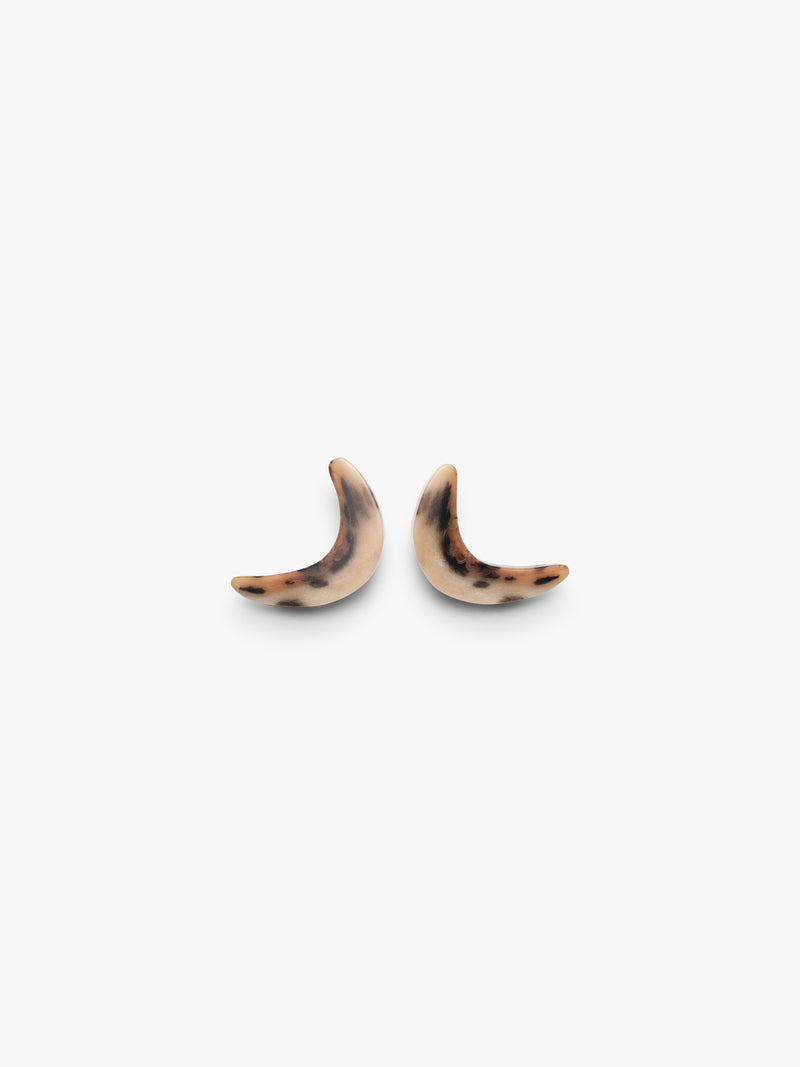 Two curved earrings in horn with animal print on a white background