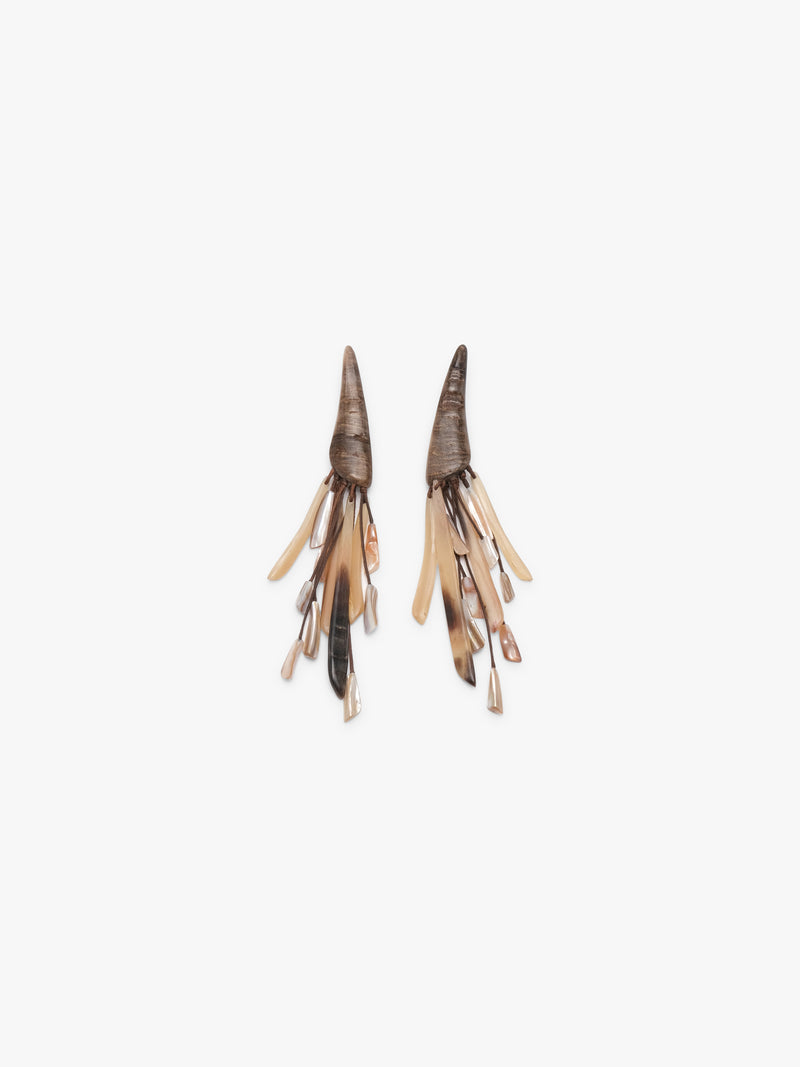 Pair of tassle earrings made from hornb and pearl on a white background