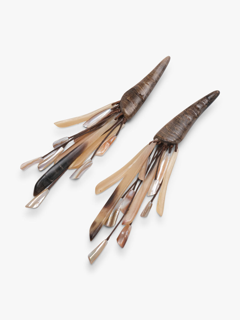 Pair of tassle earrings made from hornb and pearl on a white background