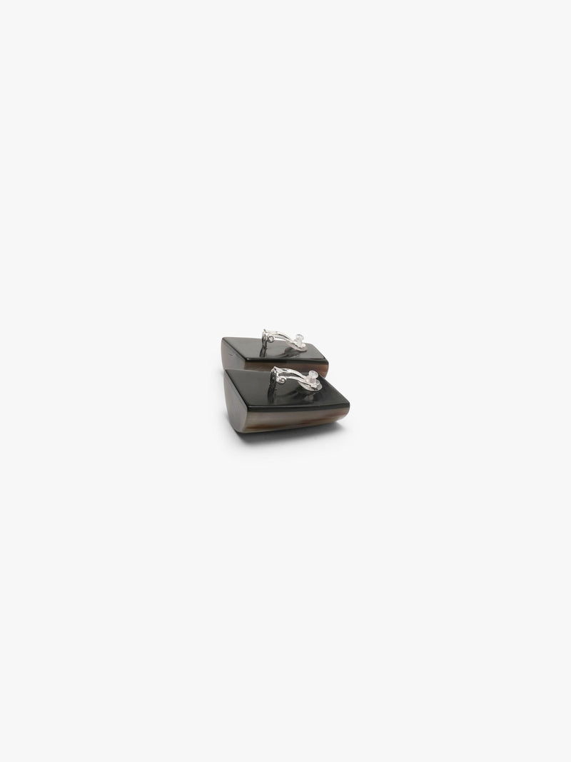 Small square earringsin horn , shown in profile against a solid off-white background.