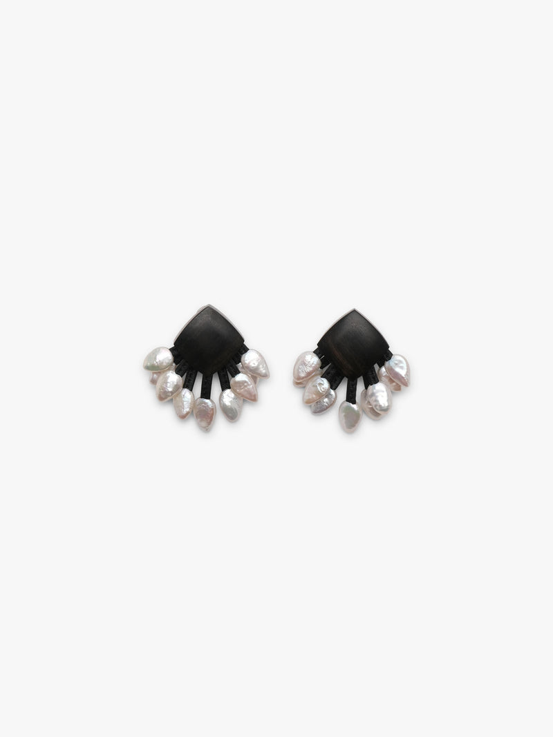 A pair of black fan-shaped stud earrings with dangling silver-toned and white freshwaterpearls, shown on a plain light gray background.