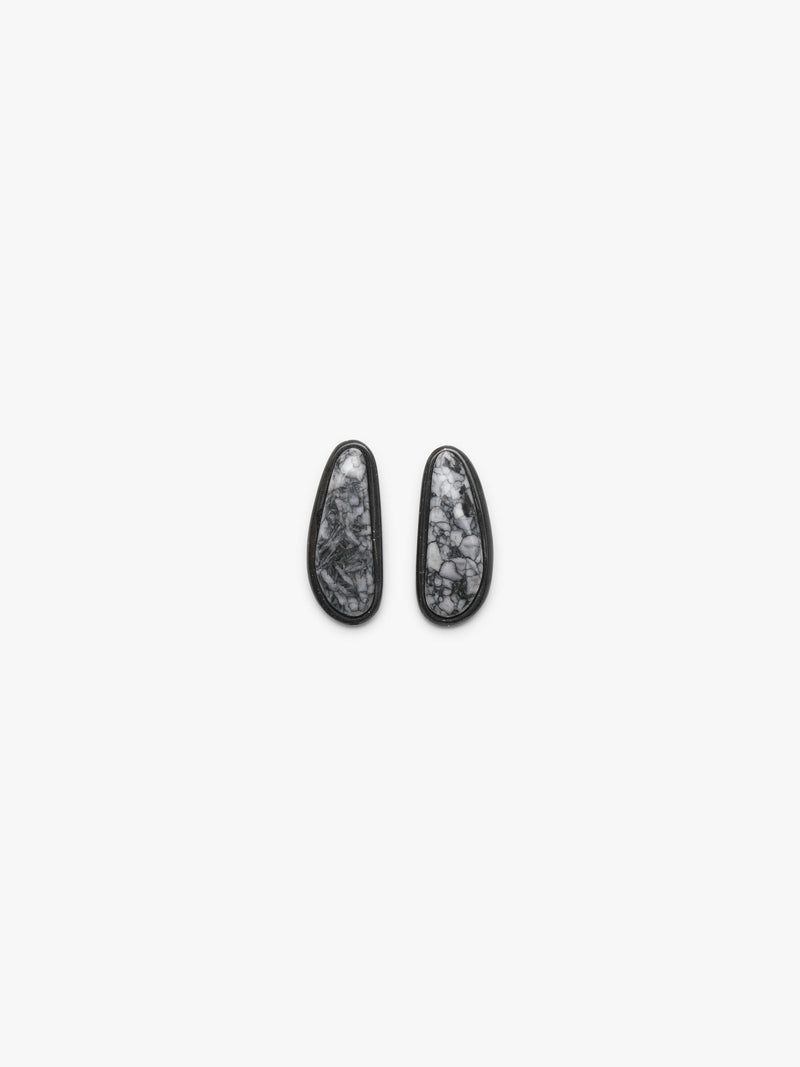 A pair of black-framed oval stud earrings with white and gray marbled stone inlays, displayed on a clean white background.