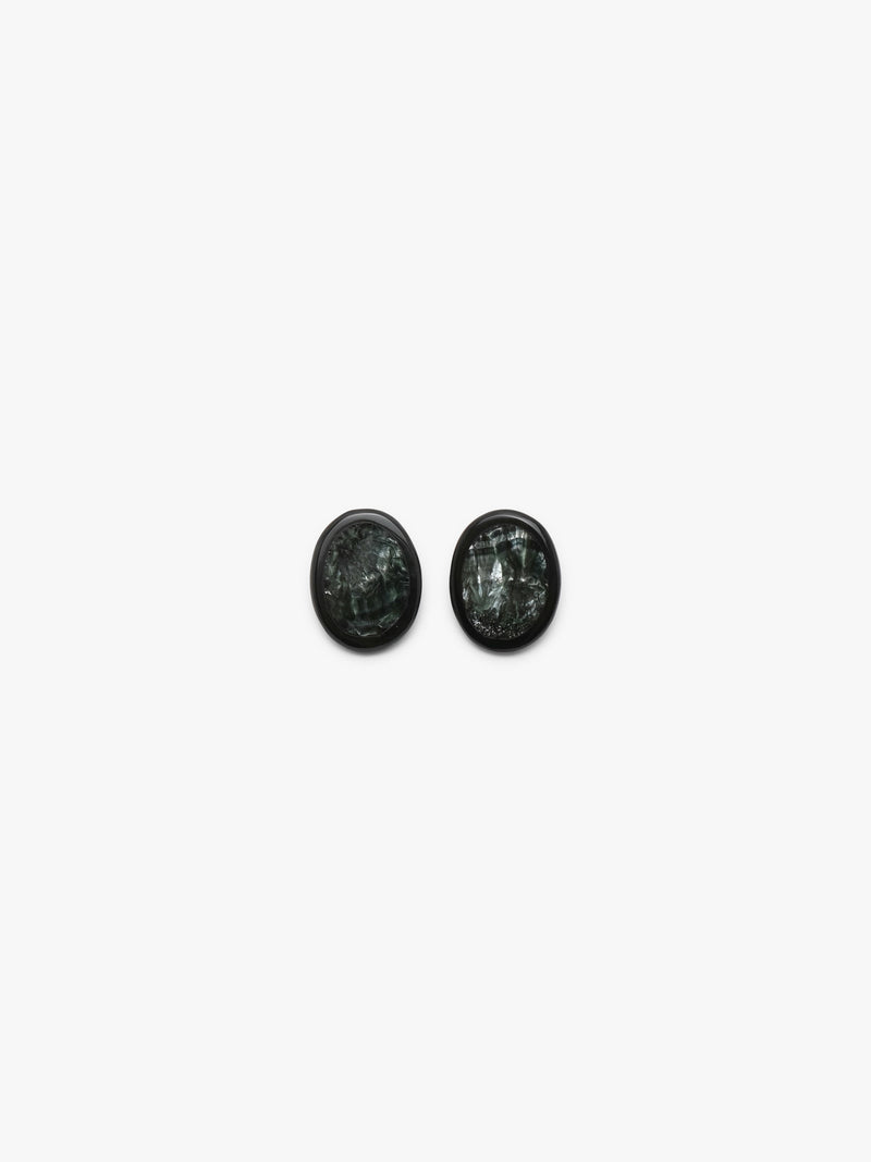 A pair of oval stud earrings with dark green, textured stone inlays set in black metal, shown on a plain light gray background.