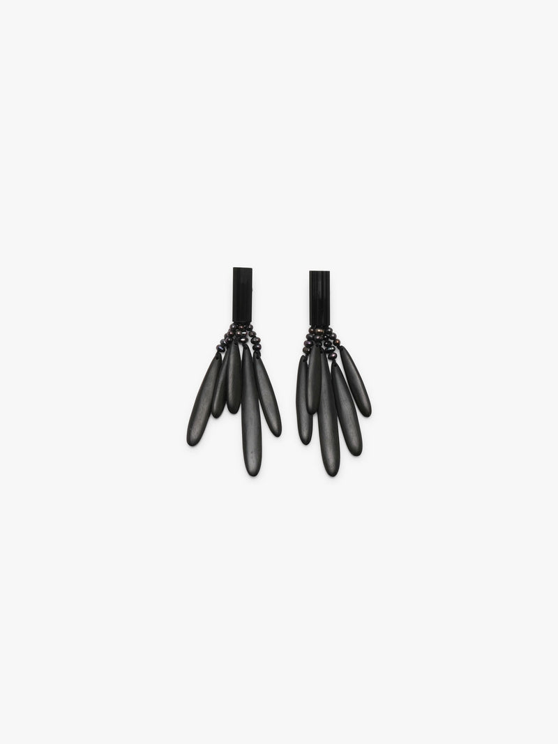 A pair of black statement dangle earrings with a textured top band and five elongated teardrop-shaped drops, shown against a plain light gray background.