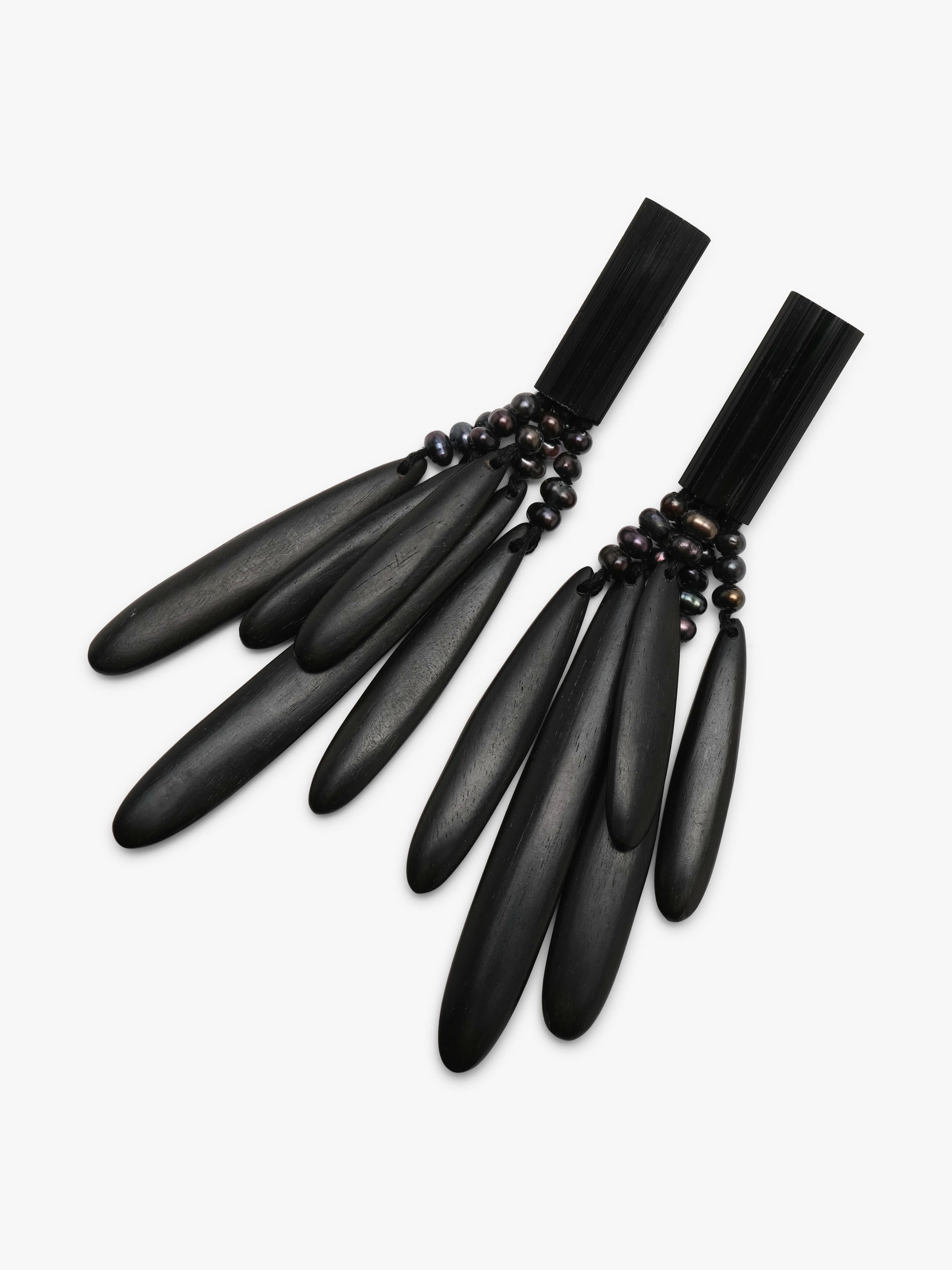 A pair of black statement earrings with multiple elongated teardrop-shaped elements and small dark beads, displayed on a clean white background.