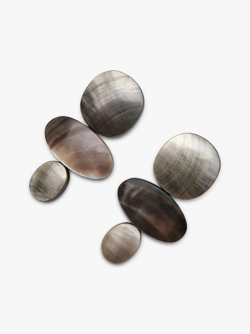 Five oval mother-of-pearl shell earrings in varying sizes, arranged on a light gray background.