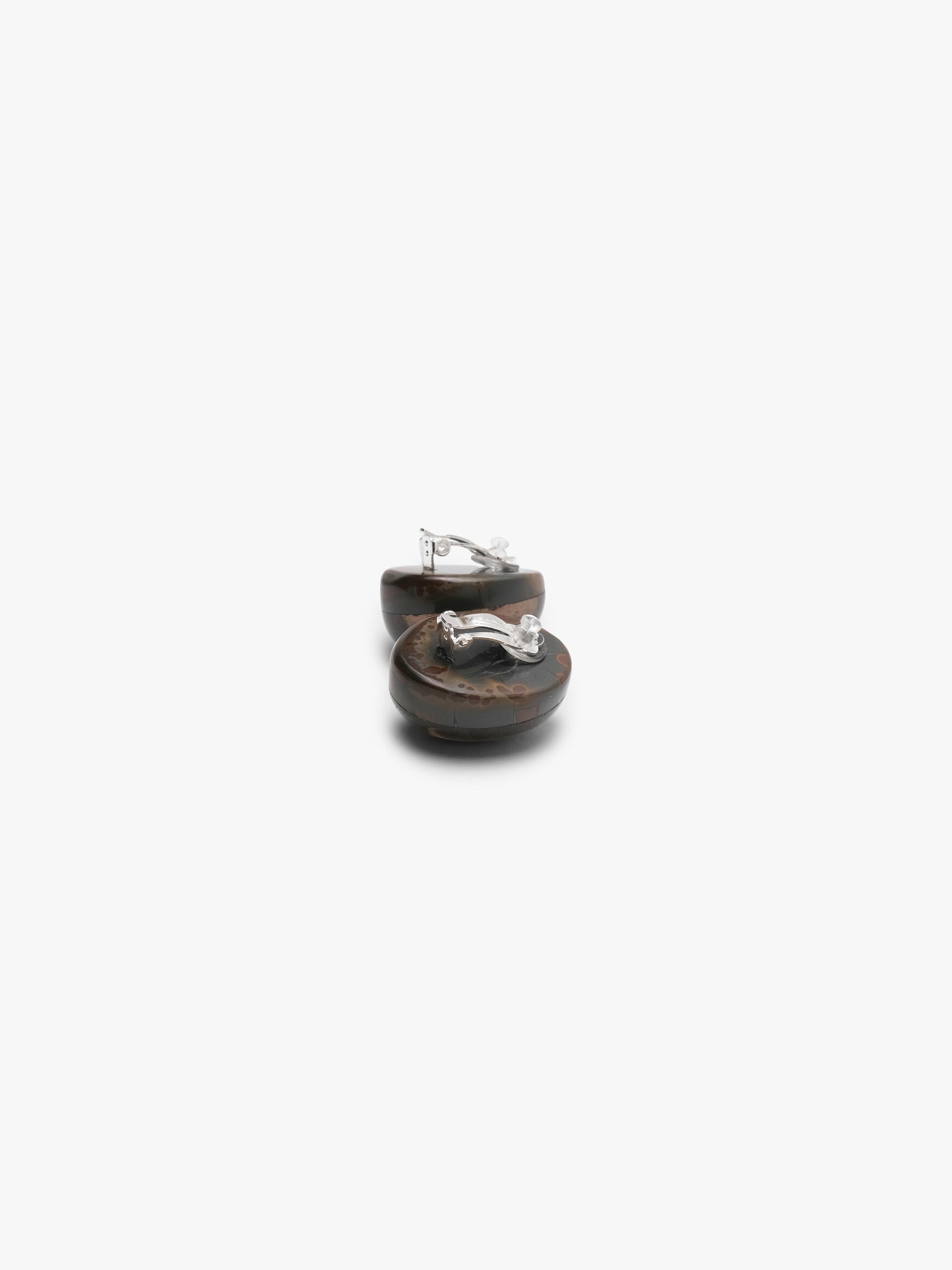The backside of Two oval cabochon earrings with a natural brown and black marbled pattern, displayed on a clean white background.