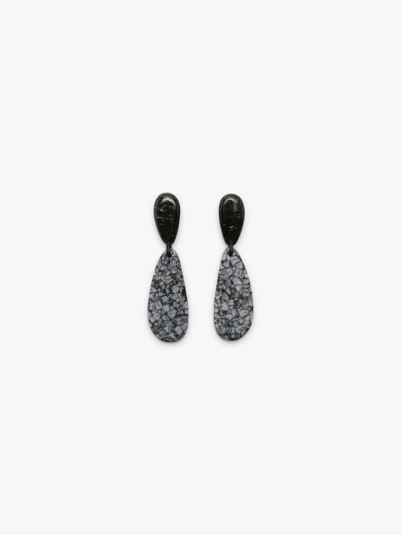 Earrings with black tops and an oval shaped stone in a textured black and grey pattern underneath, shown on a white background