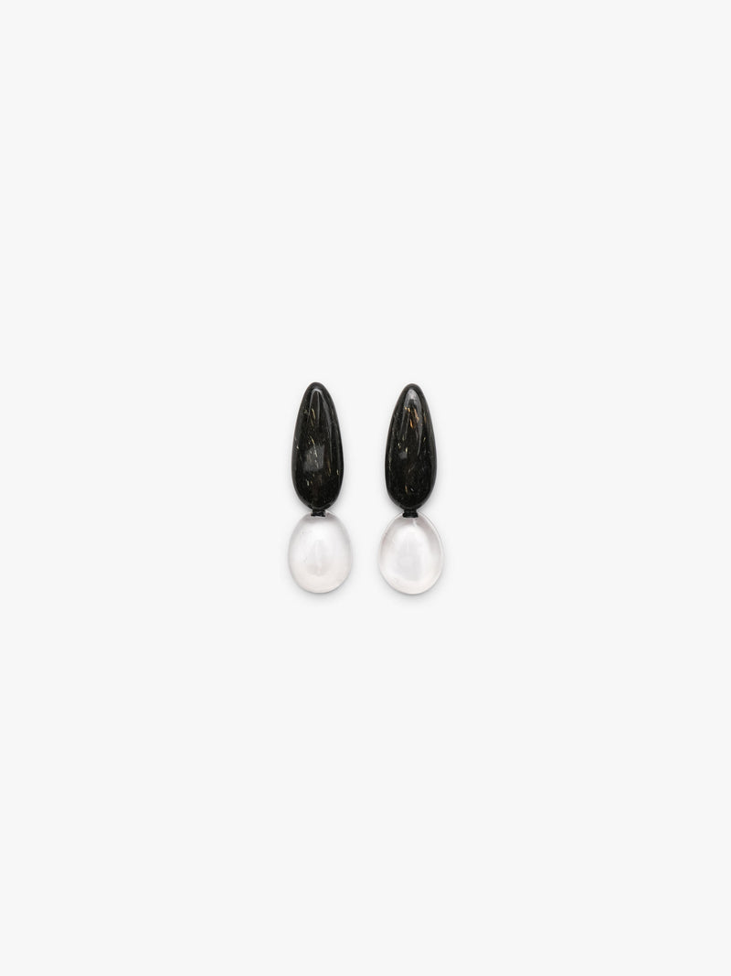 A pair of drop earrings featuring polished black obsidian teardrop pendants suspended from smooth, milky white rose quartz oval drops, shown on a clean white background.