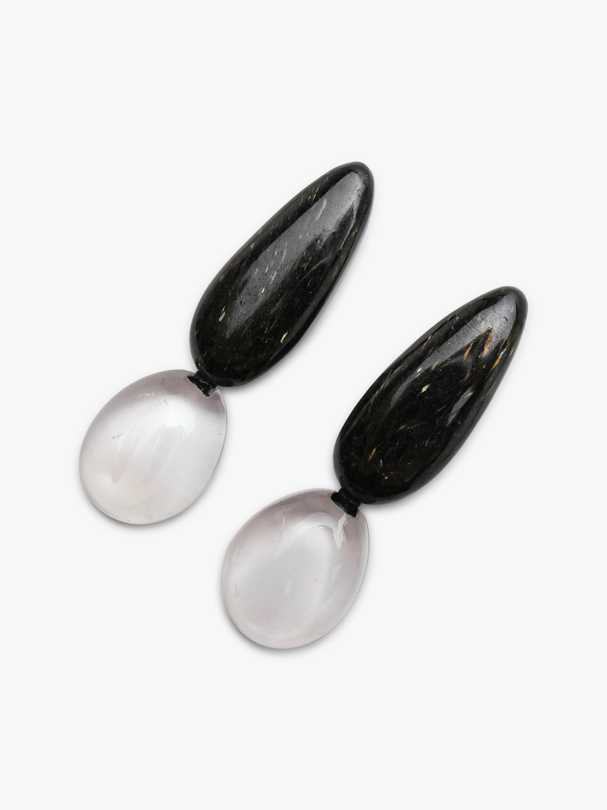 A pair of drop earrings featuring polished black obsidian teardrop pendants suspended from smooth, milky white rose quartz oval drops, shown on a clean white background.