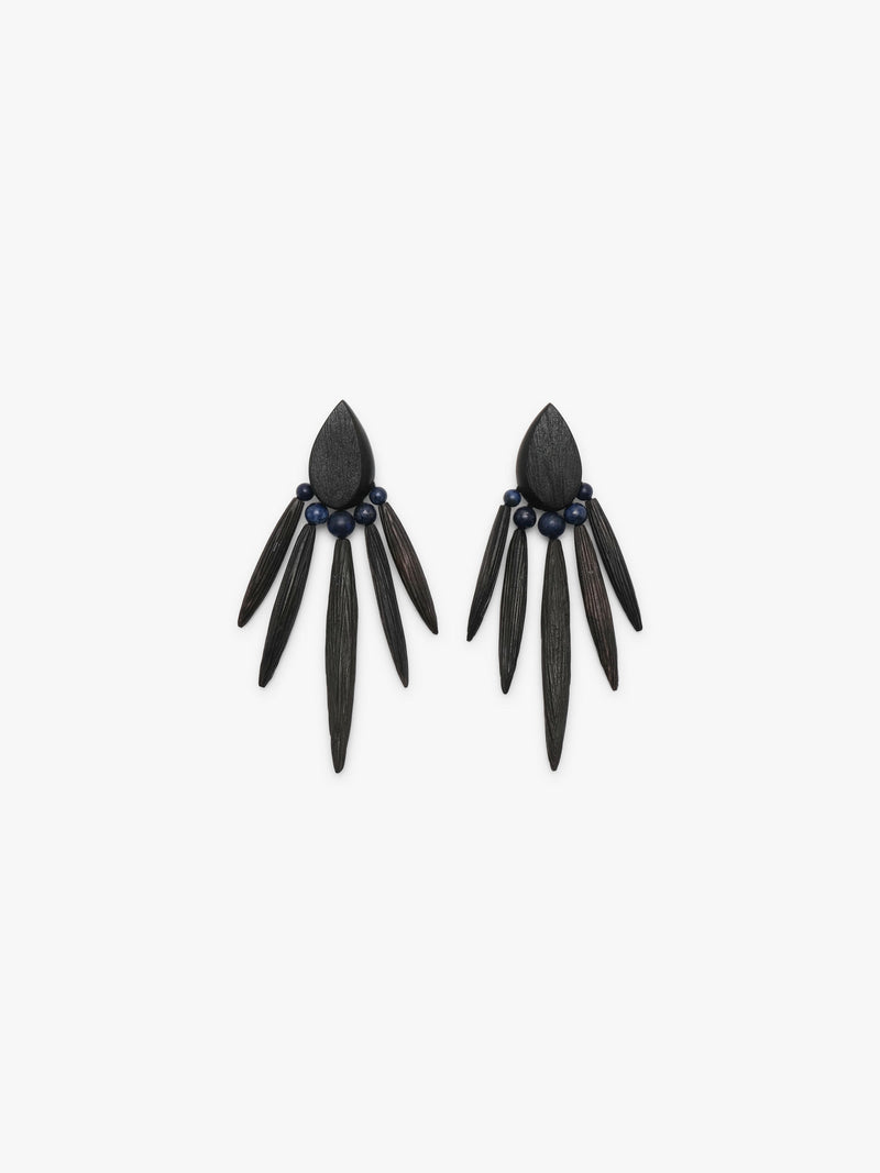 A pair of statement dangle earrings made from dark wood slices and small dark blue beads, displayed on a clean white background.