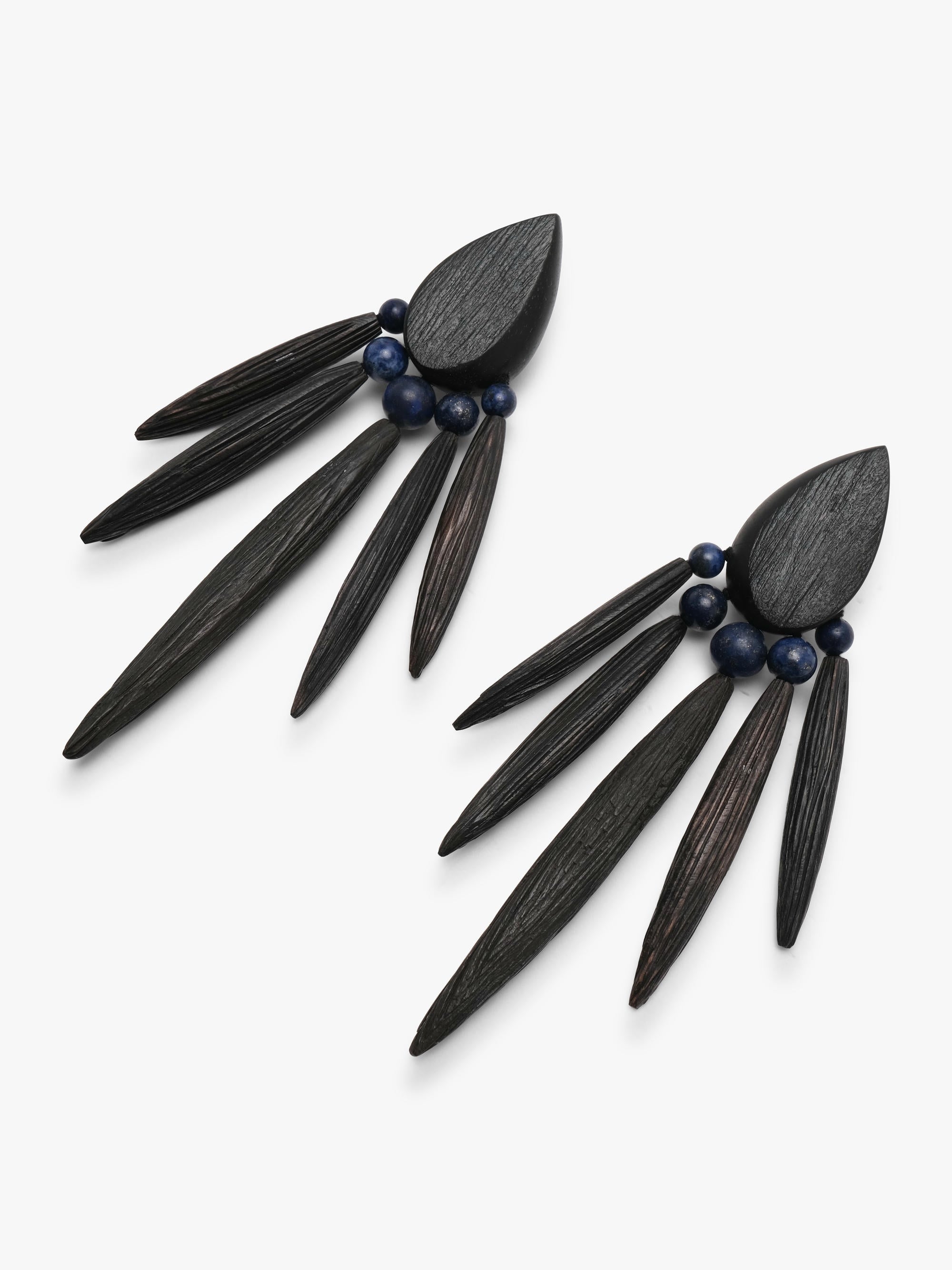 A pair of statement dangle earrings made from dark wood slices and small dark blue beads, displayed on a clean white background.
