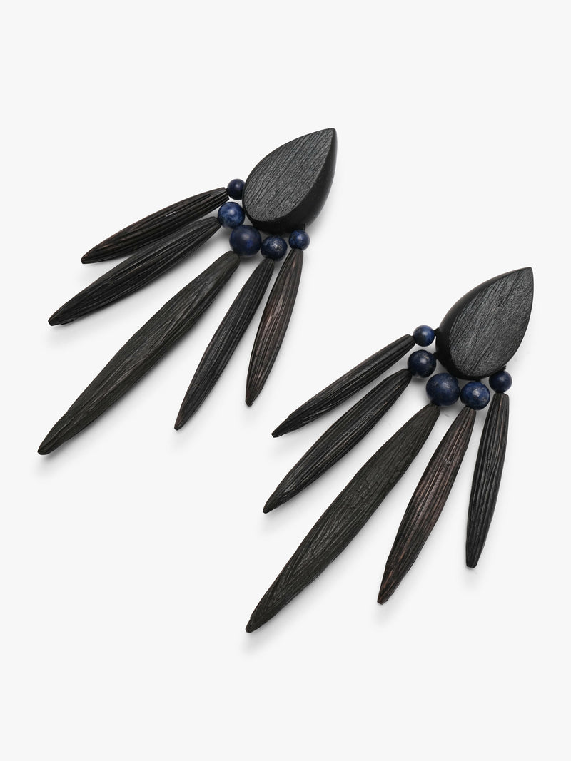 A pair of statement dangle earrings made from dark wood slices and small dark blue beads, displayed on a clean white background.
