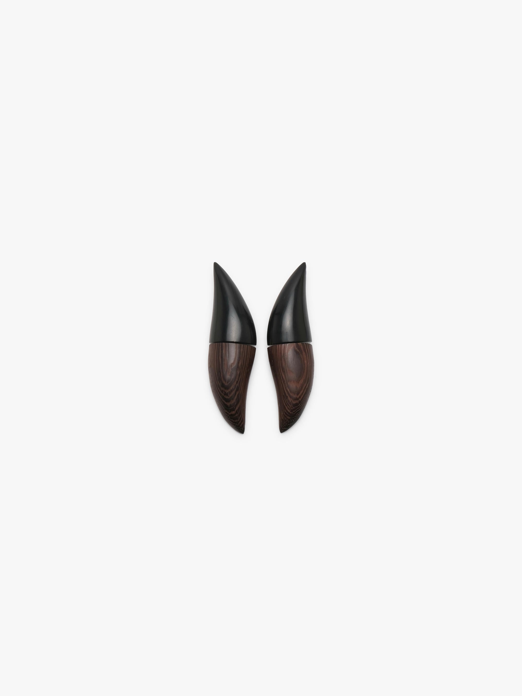 A pair of pointed black and dark brown wood earrings, displayed on a clean white background.
