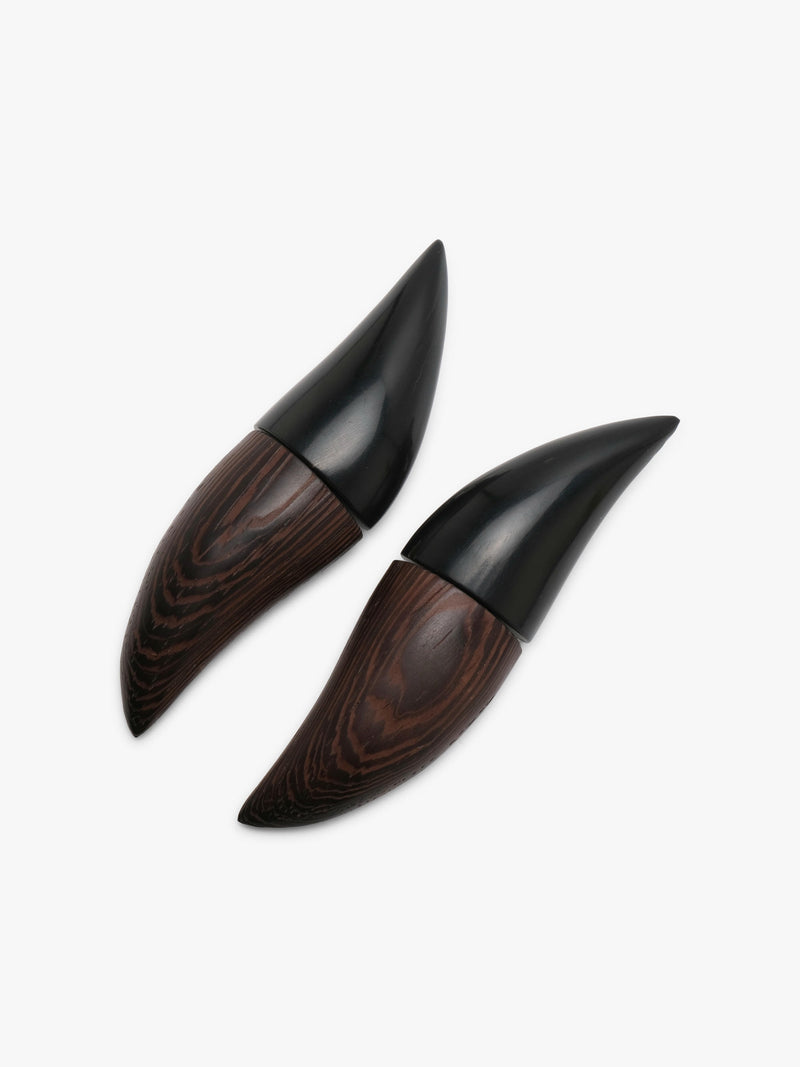 A pair of pointed black and dark brown wood earrings, displayed on a clean white background.
