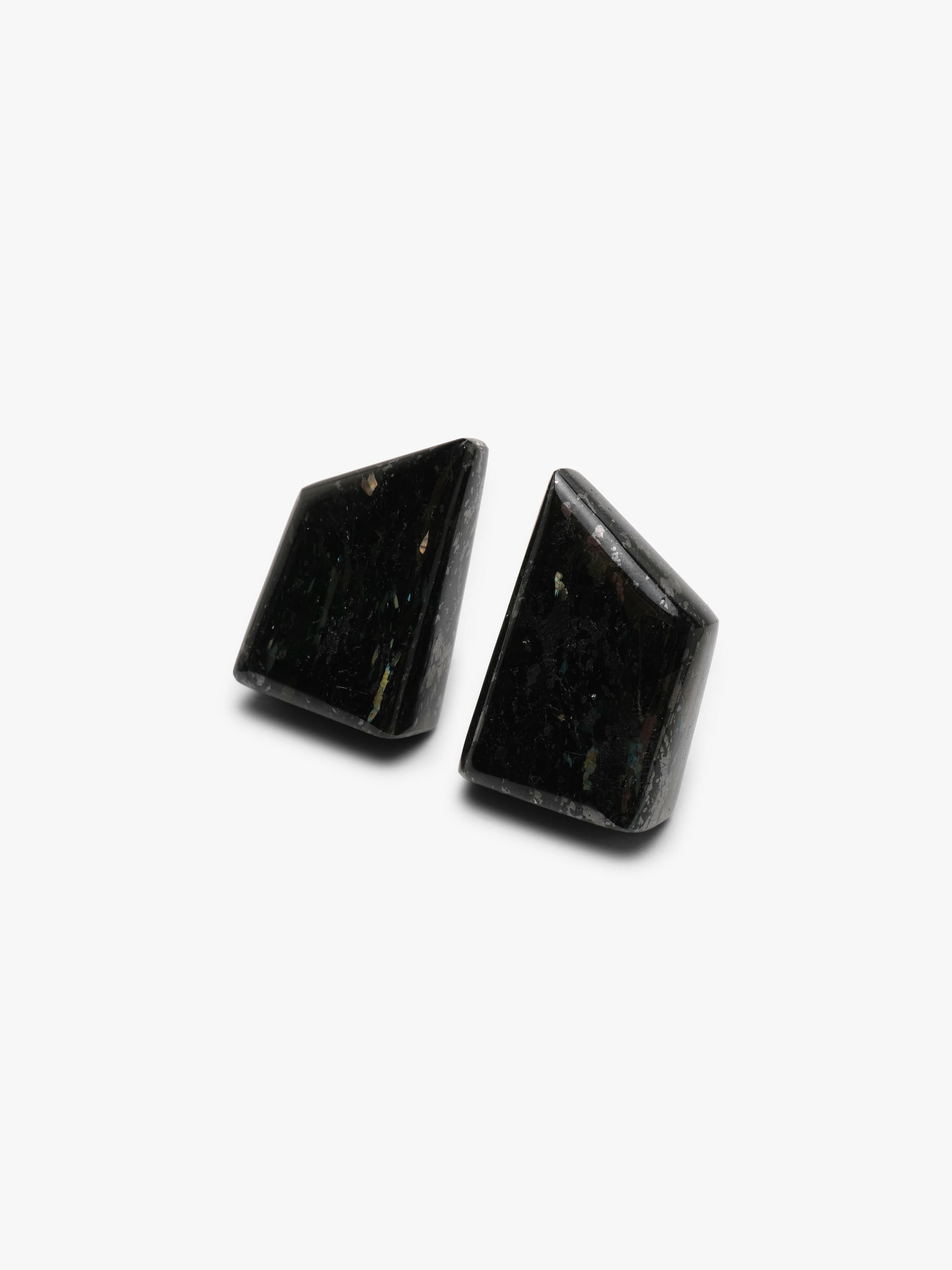 Black button earrings with small inclusions, shown on a white background