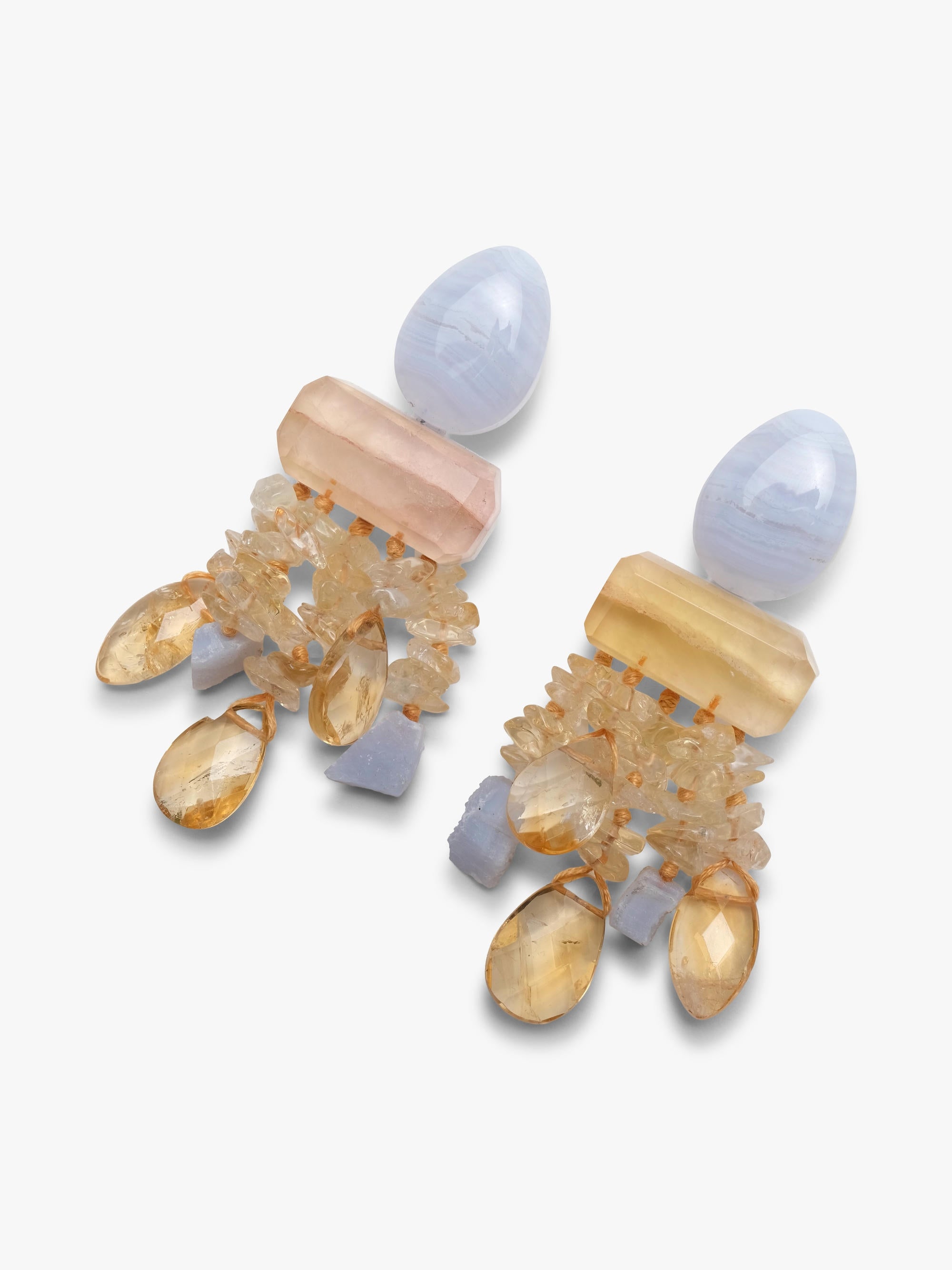 Dangle earrings in purple and yellow stones. Displayed on a white background