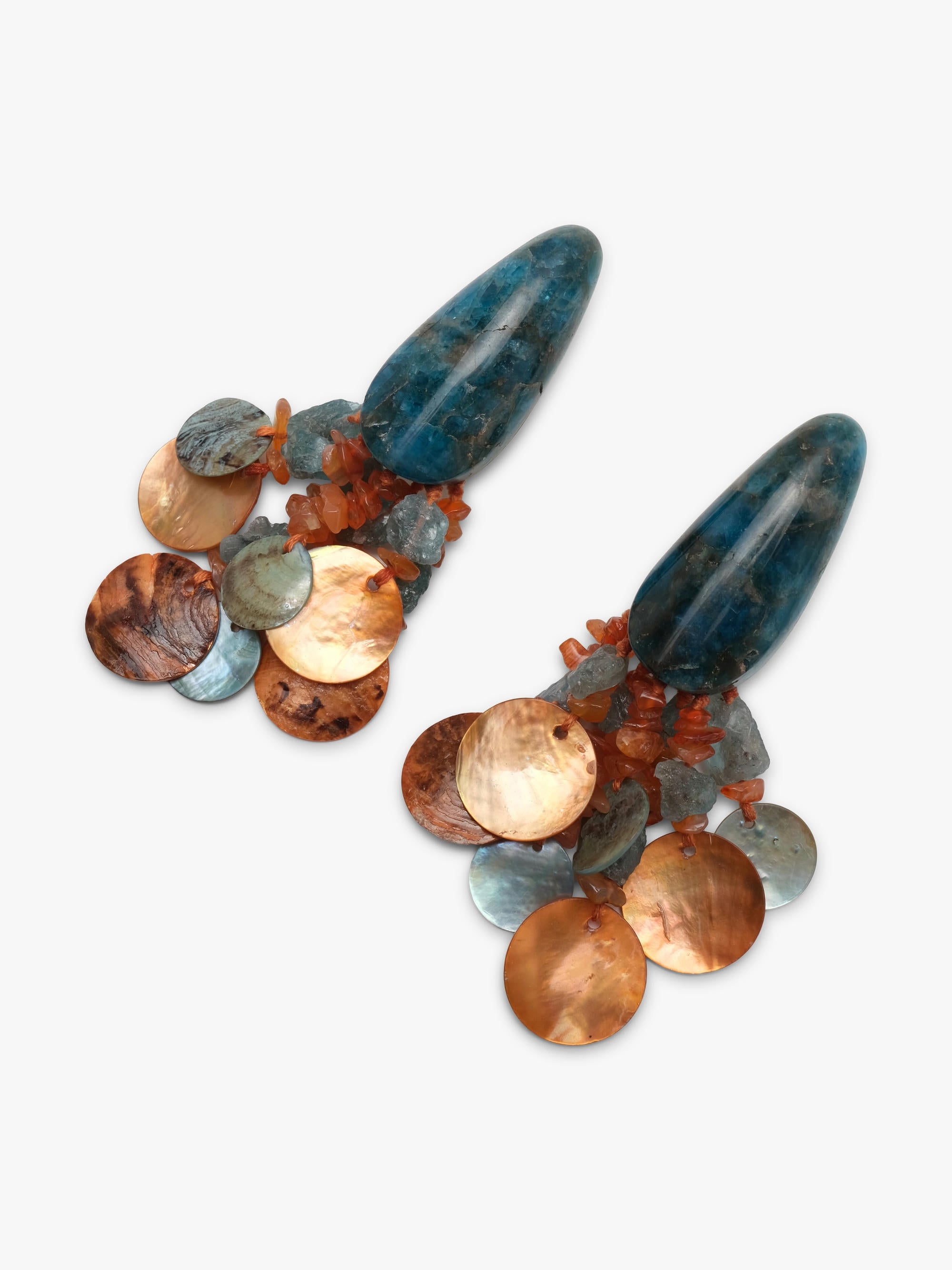 A pair of statement dangle earrings featuring elongated dark blue-green stone tops and clusters of faceted round beads in copper, bronze, and iridescent tones, set against a plain light gray background.