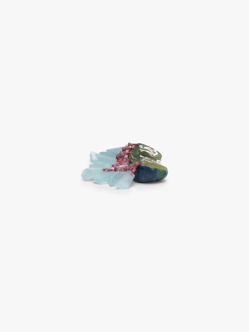 A pair of unique dangle earrings featuring dark blue-green stone tops with delicate pinkish-red fringed details and light blue translucent hanging elements, set against a plain white background.