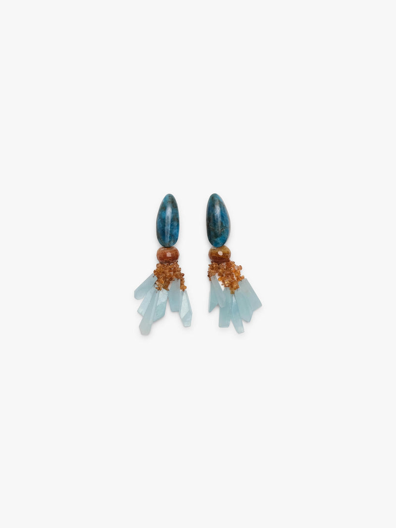 A pair of statement dangle earrings featuring polished blue-green teardrop beads, light blue crystal clusters, and textured orange-brown metallic accents, displayed on a clean off-white background.