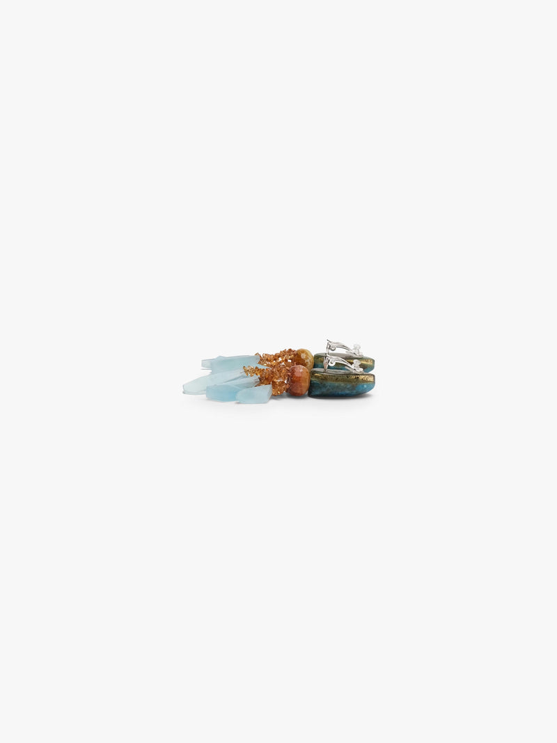 A pair of statement dangle earrings featuring polished blue-green teardrop beads, light blue crystal clusters, and textured orange-brown metallic accents, displayed on a clean off-white background.