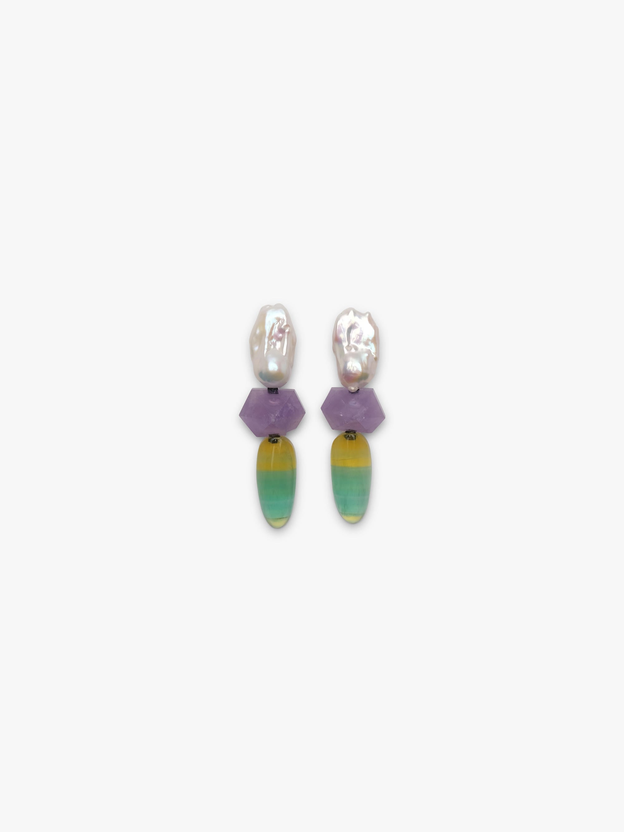 Baroque pearl dangle earrings with purple and yellowish green stones underneath. Displayed on a white background