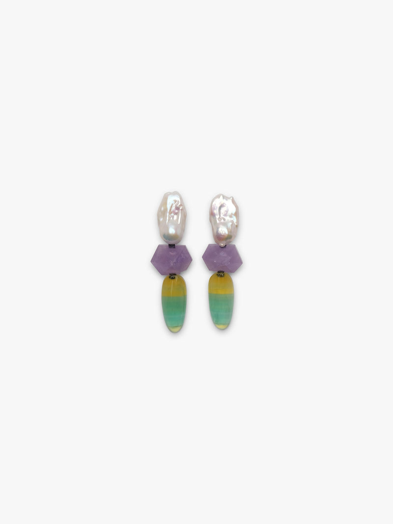 Baroque pearl dangle earrings with purple and yellowish green stones underneath. Displayed on a white background