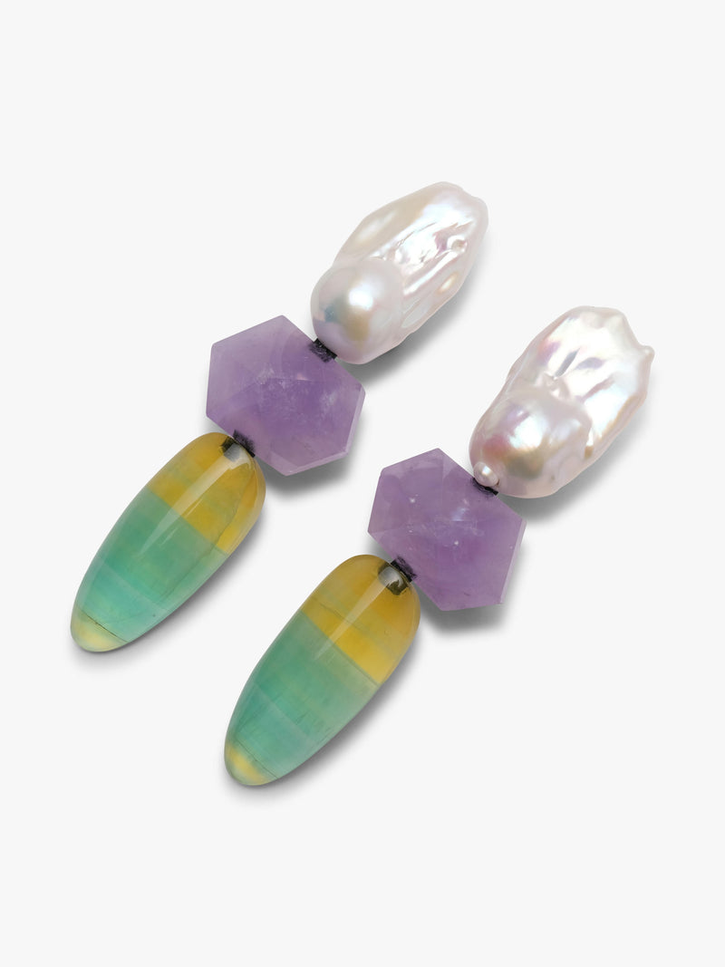 Baroque pearl dangle earrings with purple and yellowish green stones underneath. Displayed on a white background